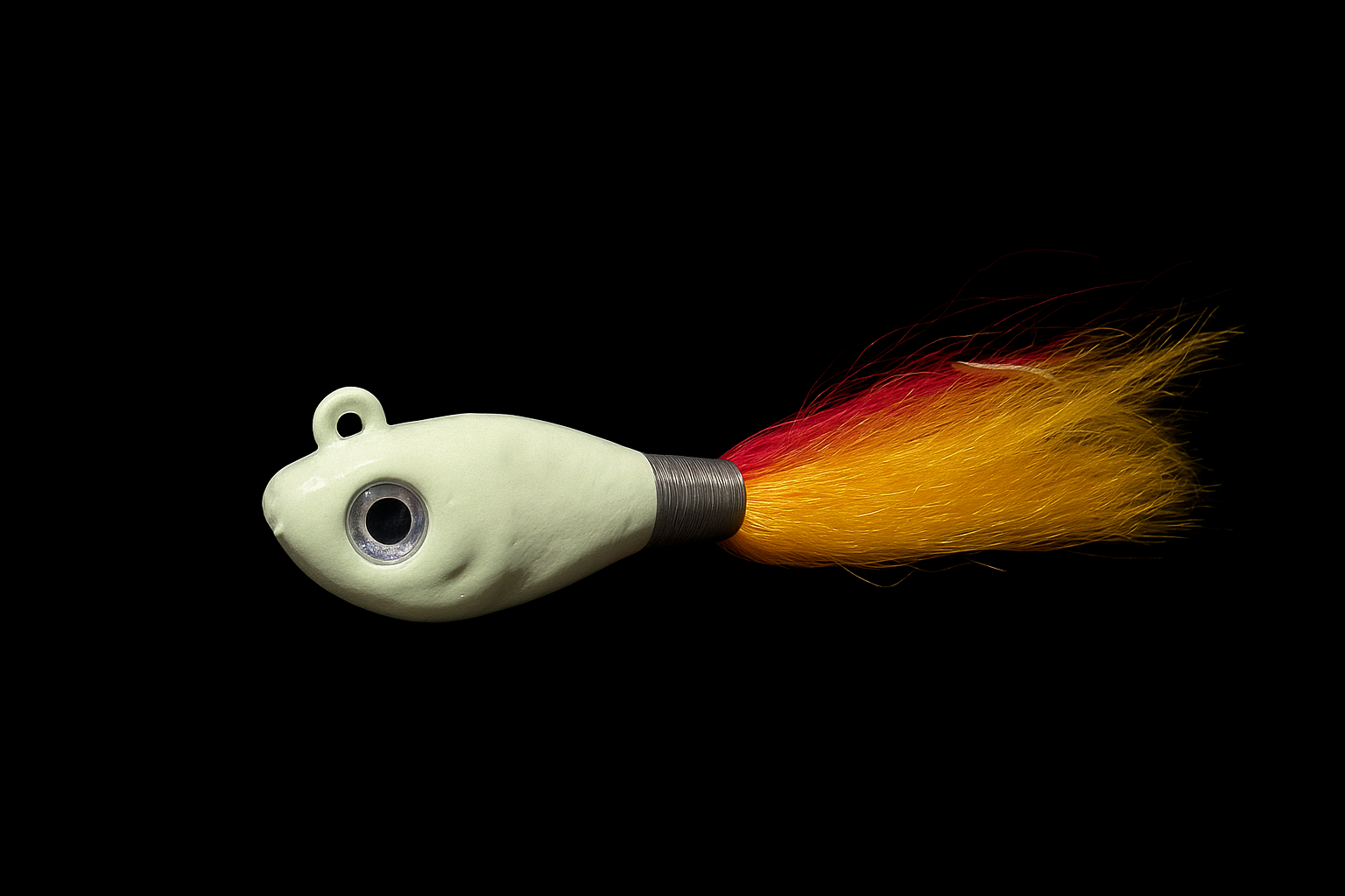 A fishing lure designed to resemble a small fish, with a hook and a streamer tail that appears as a fiery tail with red, yellow, and orange wispy strands.