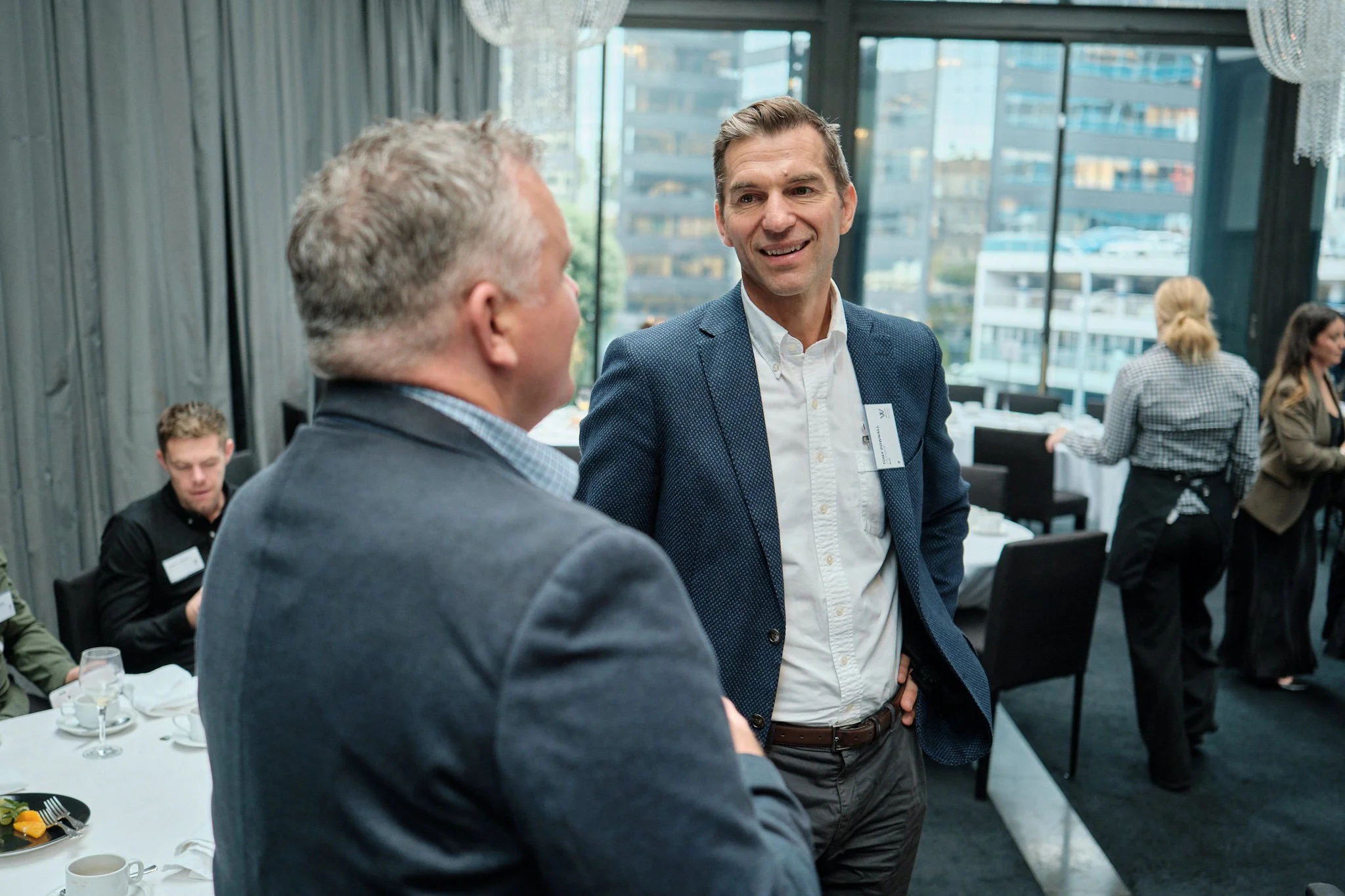 Two Business Leaders having a conversation at a Weave Leadership event