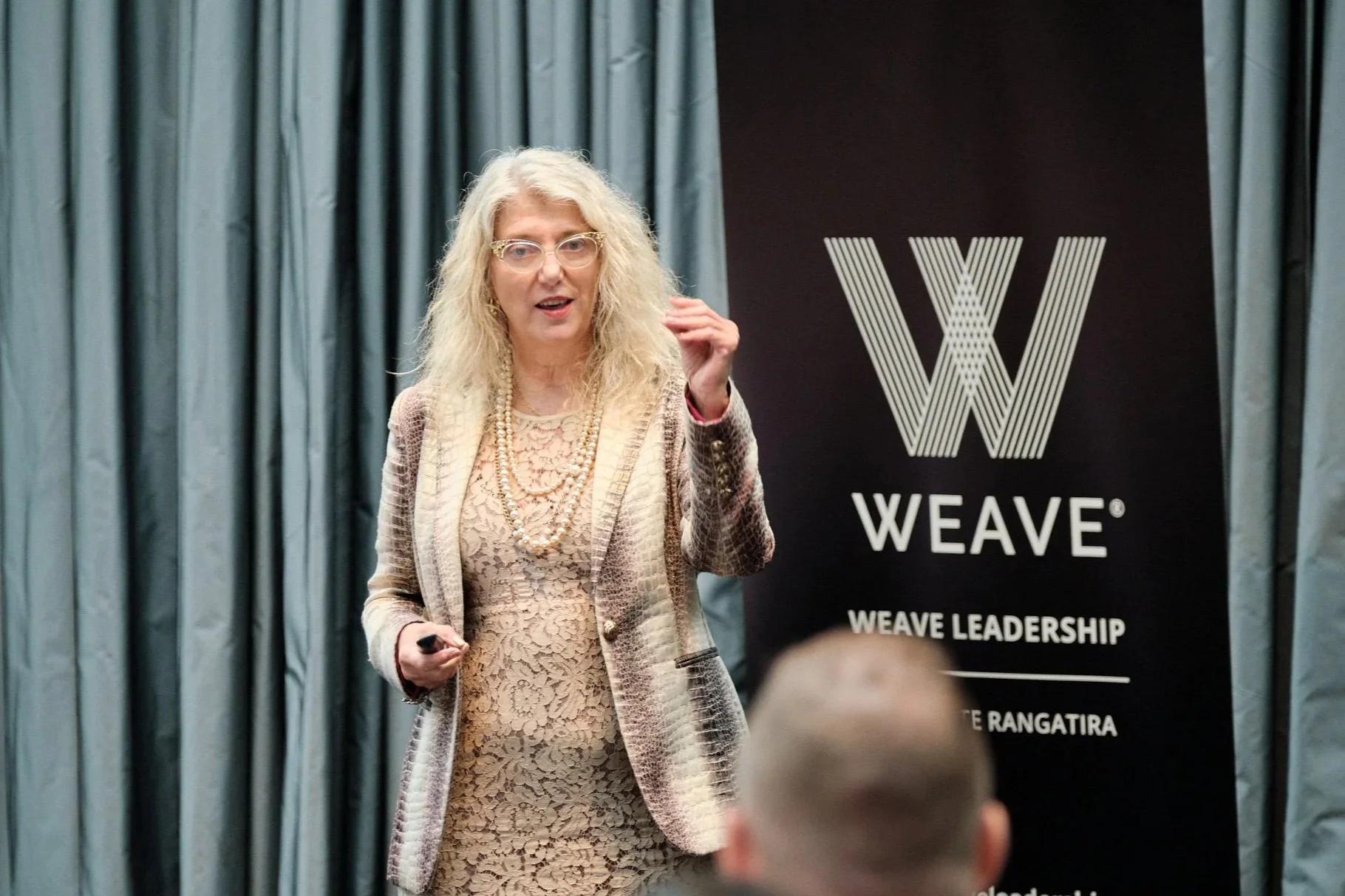 Female business leader presenting to a group at a Weave Leadership Emerging Leaders Programme