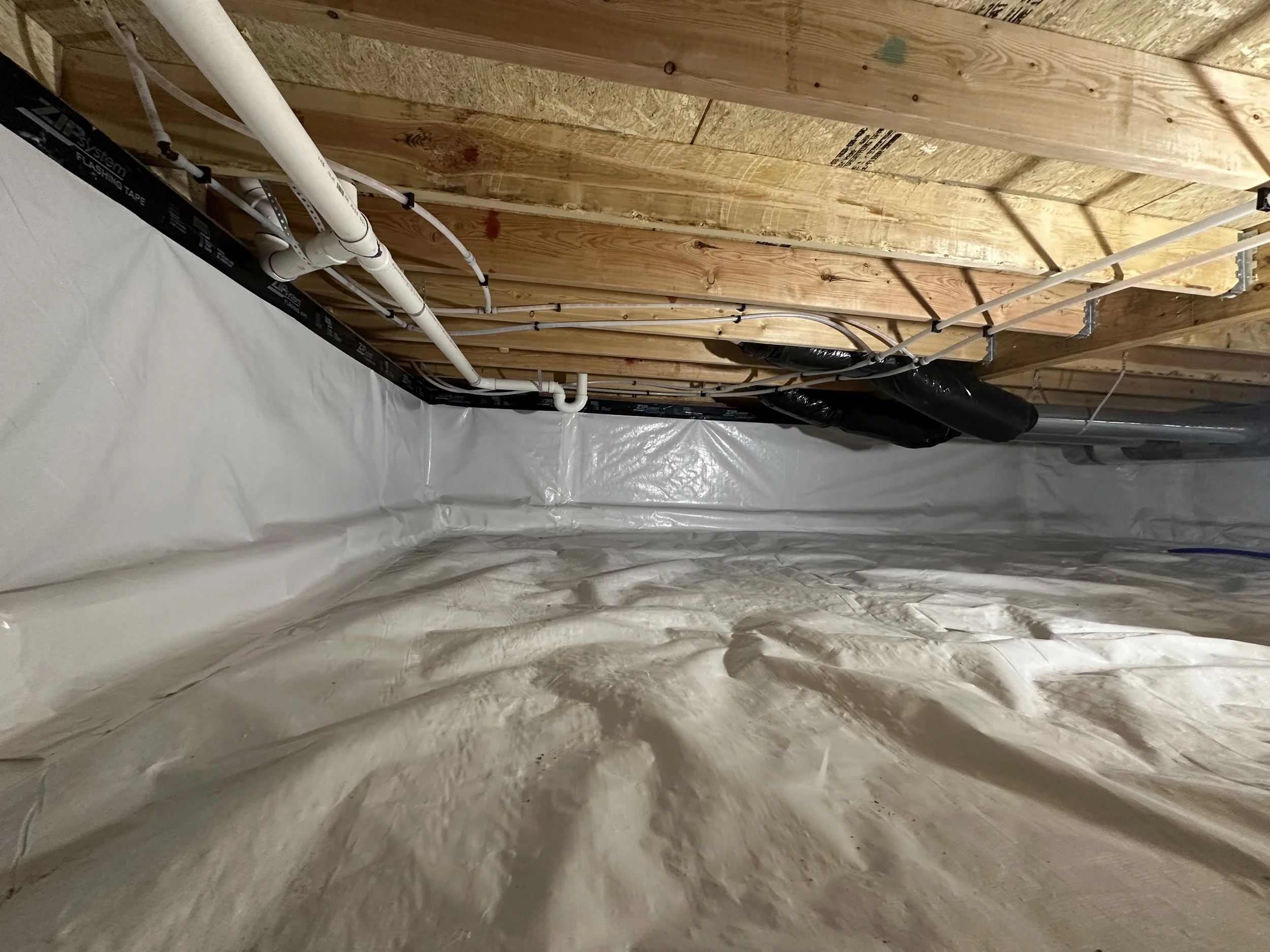A sealed vapor barrier in a crawlspace