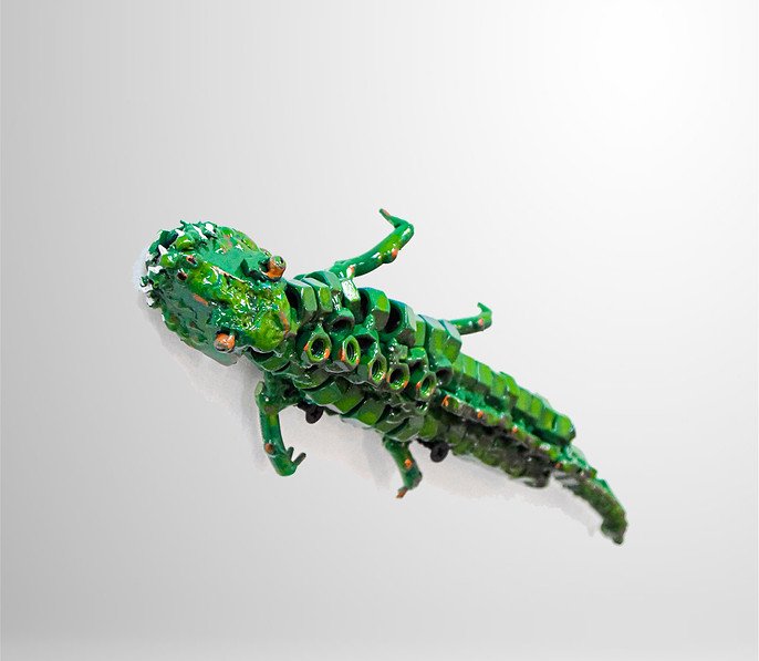Green alligator sculpture made from metal parts