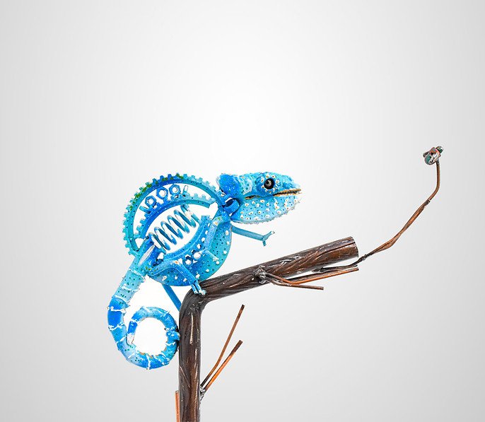 Sculpture of blue chameleon on a branch