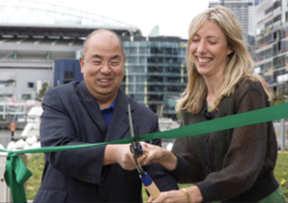 Councillor Lui and Emily cutting the ribbon for the Docklands Community garden opening.