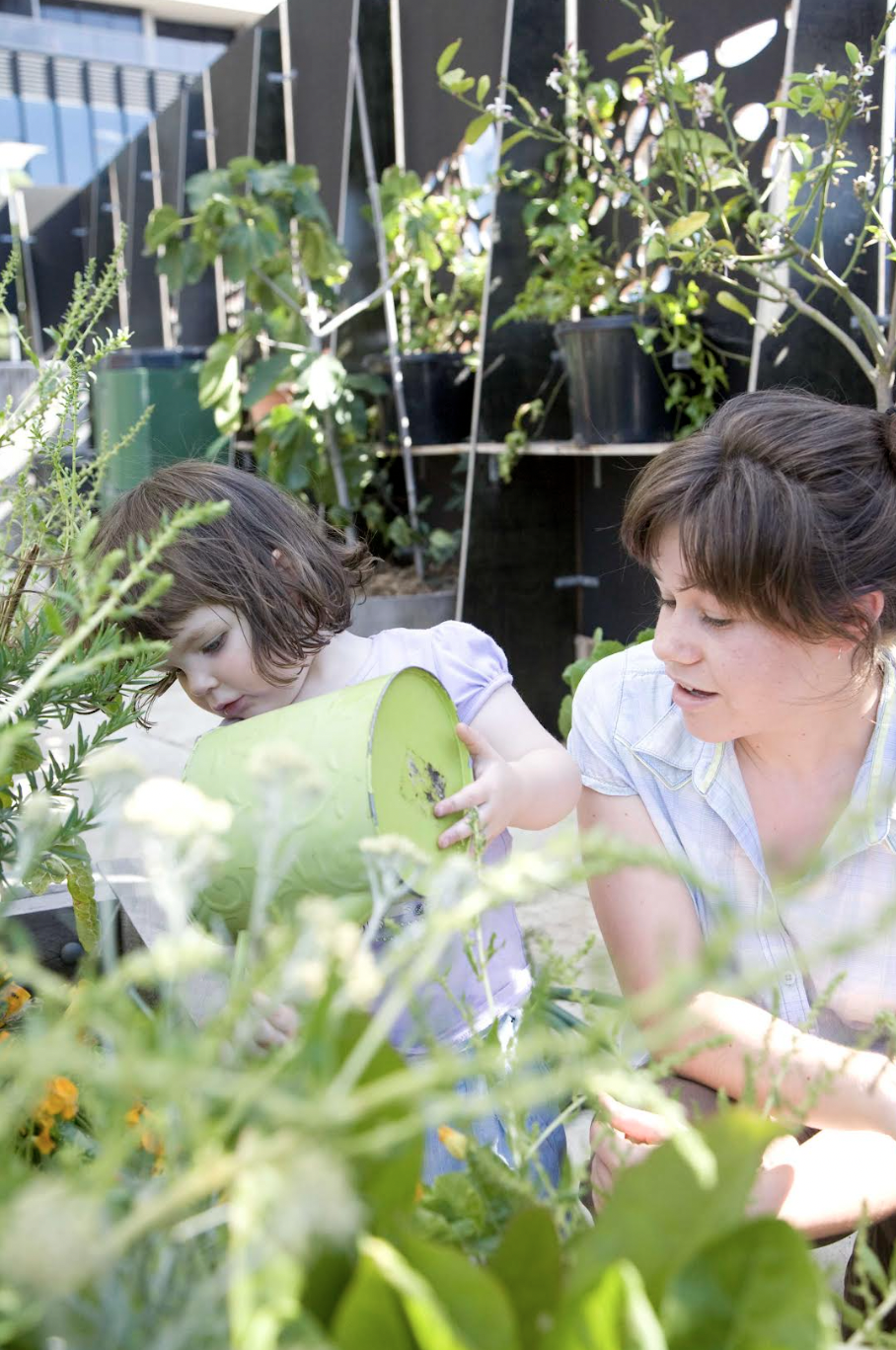 Children and Mums finding refuge in the demonstration garden on a conrete slab in the Docklands. By Hilary Bradford Photography