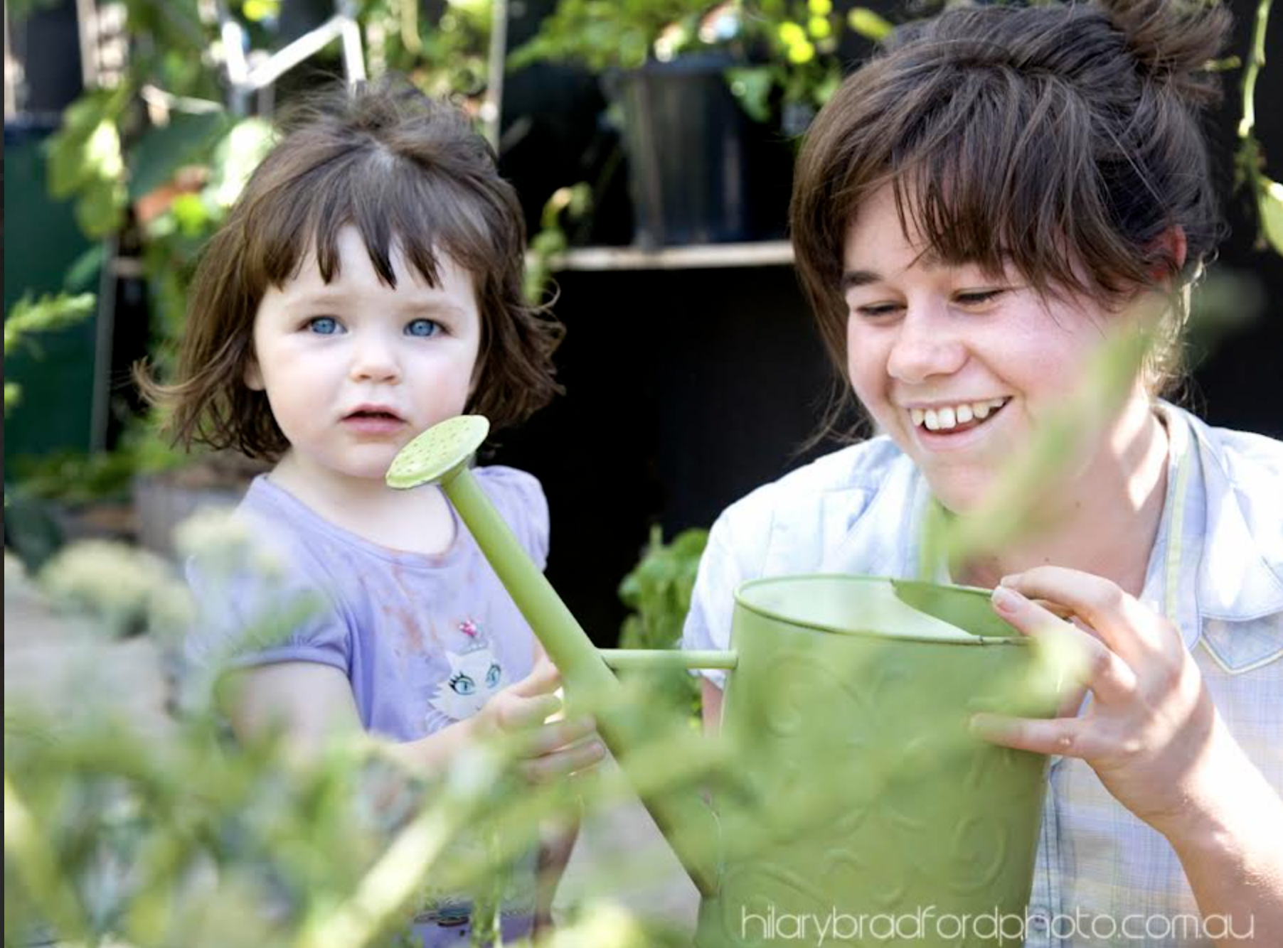 Children and Mums finding refuge in the demonstration garden on a conrete slab in the Docklands. By Hilary Bradford Photography