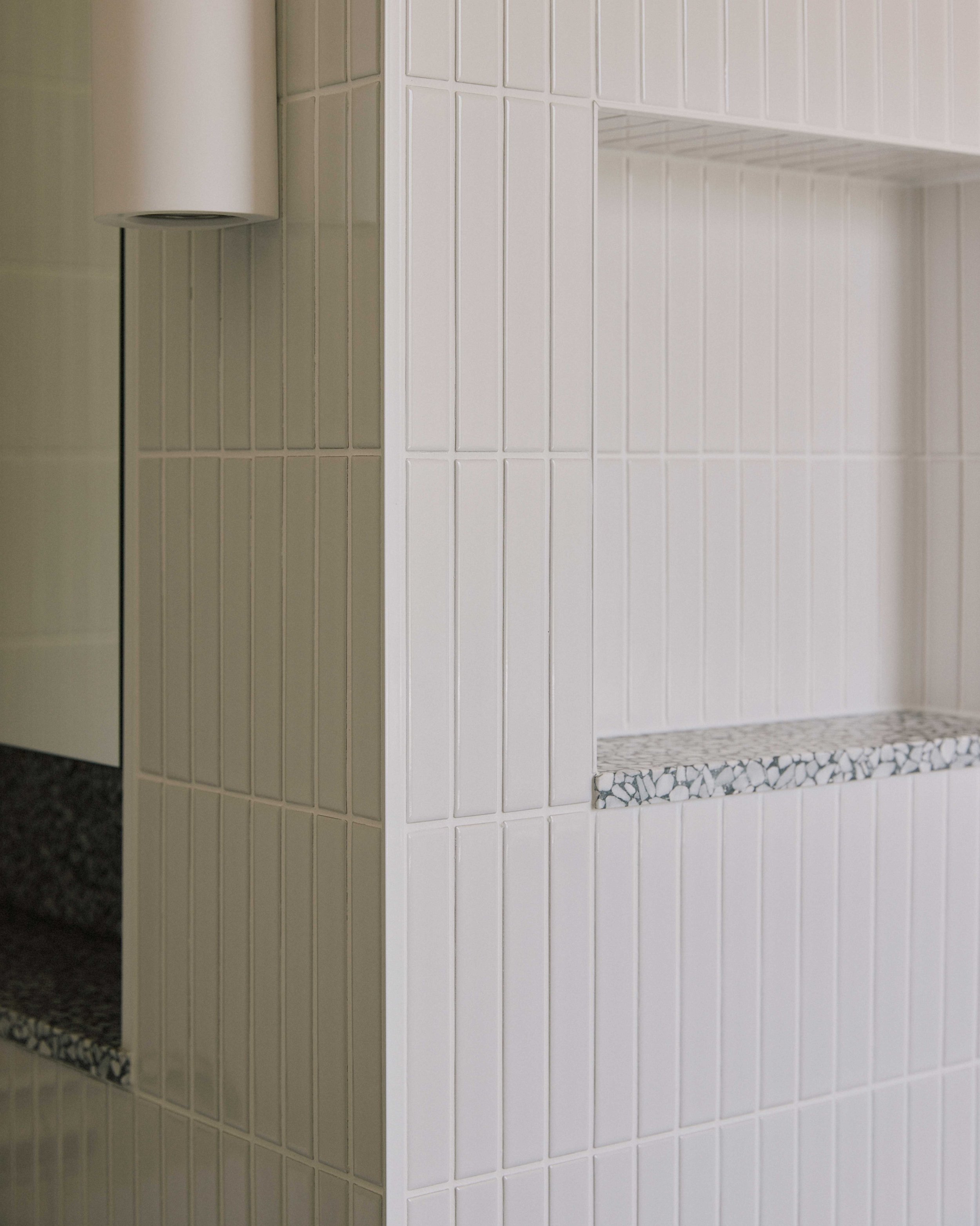 Bathroom storage niche Berrima - white tiles terrazzo shelf detail ZF Architects renovation