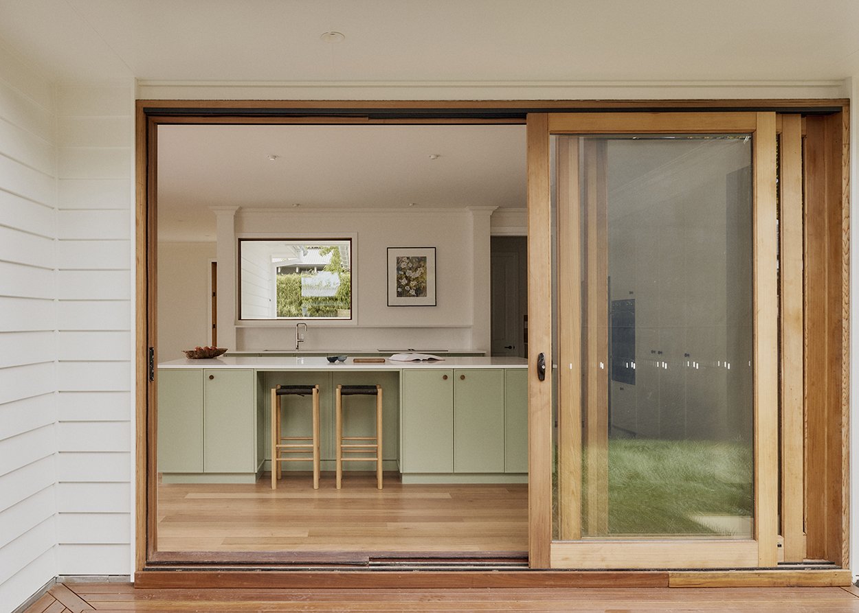 Kitchen viewed through open timber-framed sliding door from the northern sun-deck, Mittagong Courtyard Cottage
