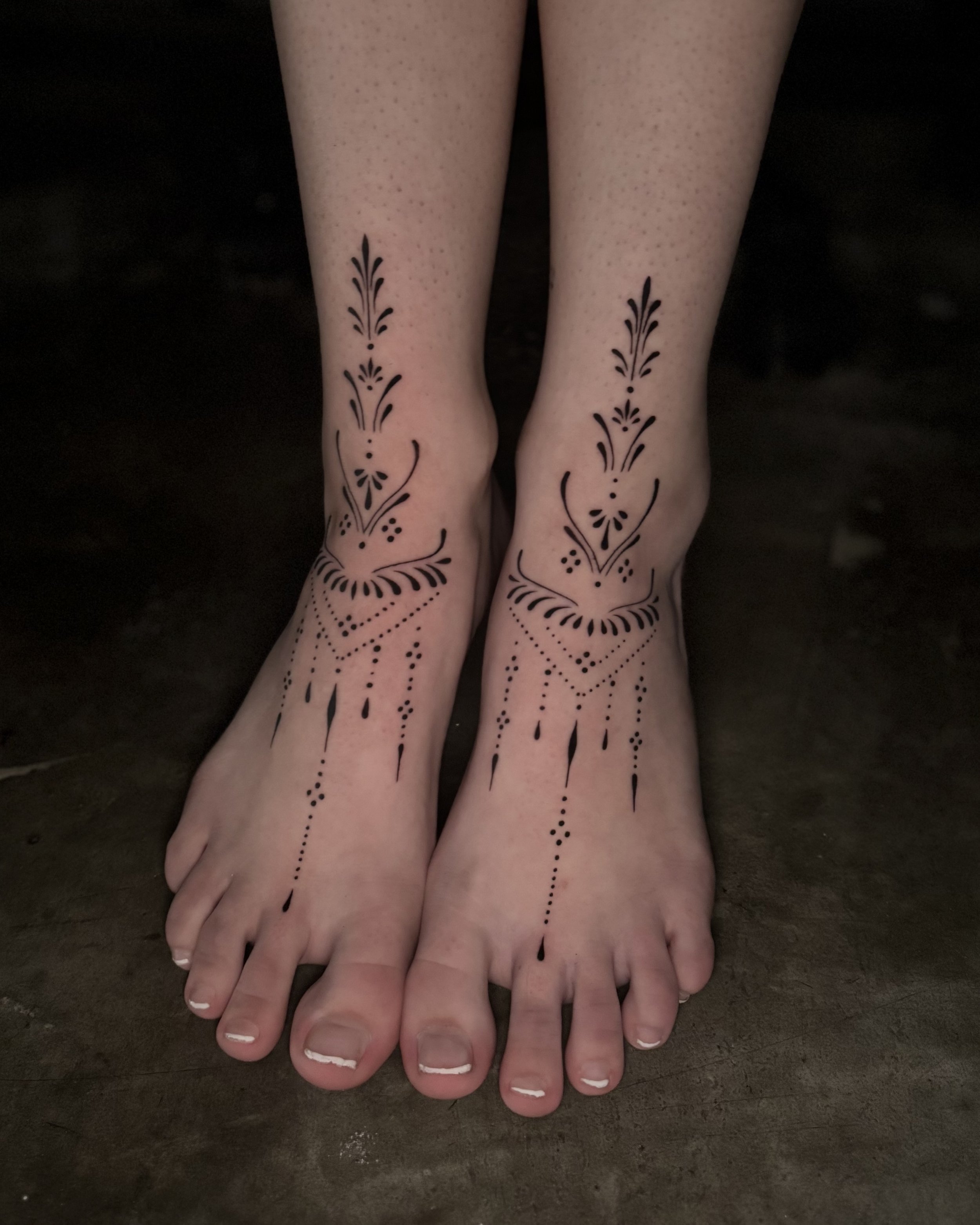 Fine line ornamental tattoo by Soleya Tattoo in Auckland — minimalist foot design featuring symmetrical mandala-inspired elements. A clean and balanced piece highlighting precision, structure, and modern tattoo aesthetics.