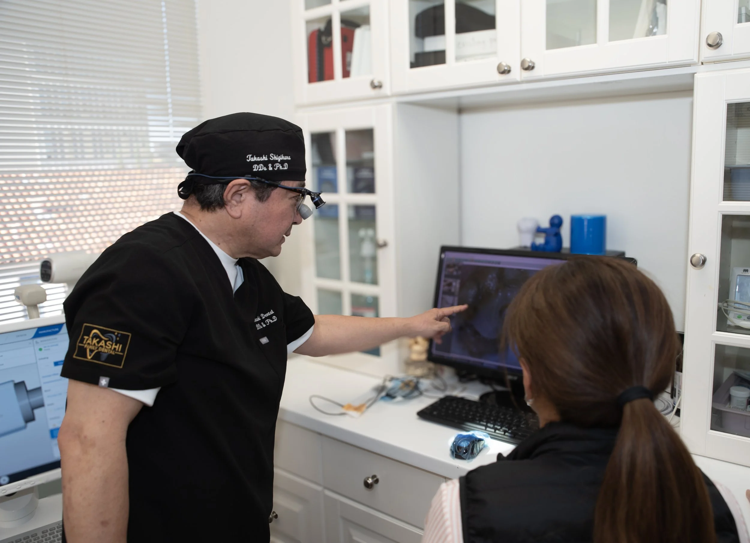 Dr. Takashi explaining a clinical photo to a patient