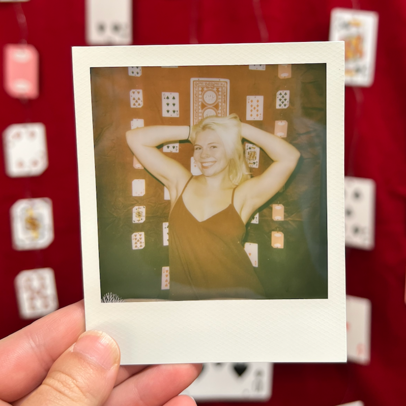 Polaroid photo booth rental setup with instant film photo in hand