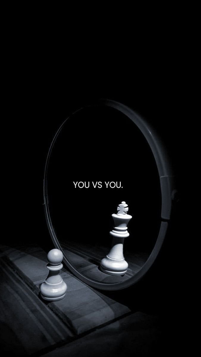 A mirror with a chess king and pawn piece in front of it, with the text 'YOU VS YOU.' reflected in the mirror.