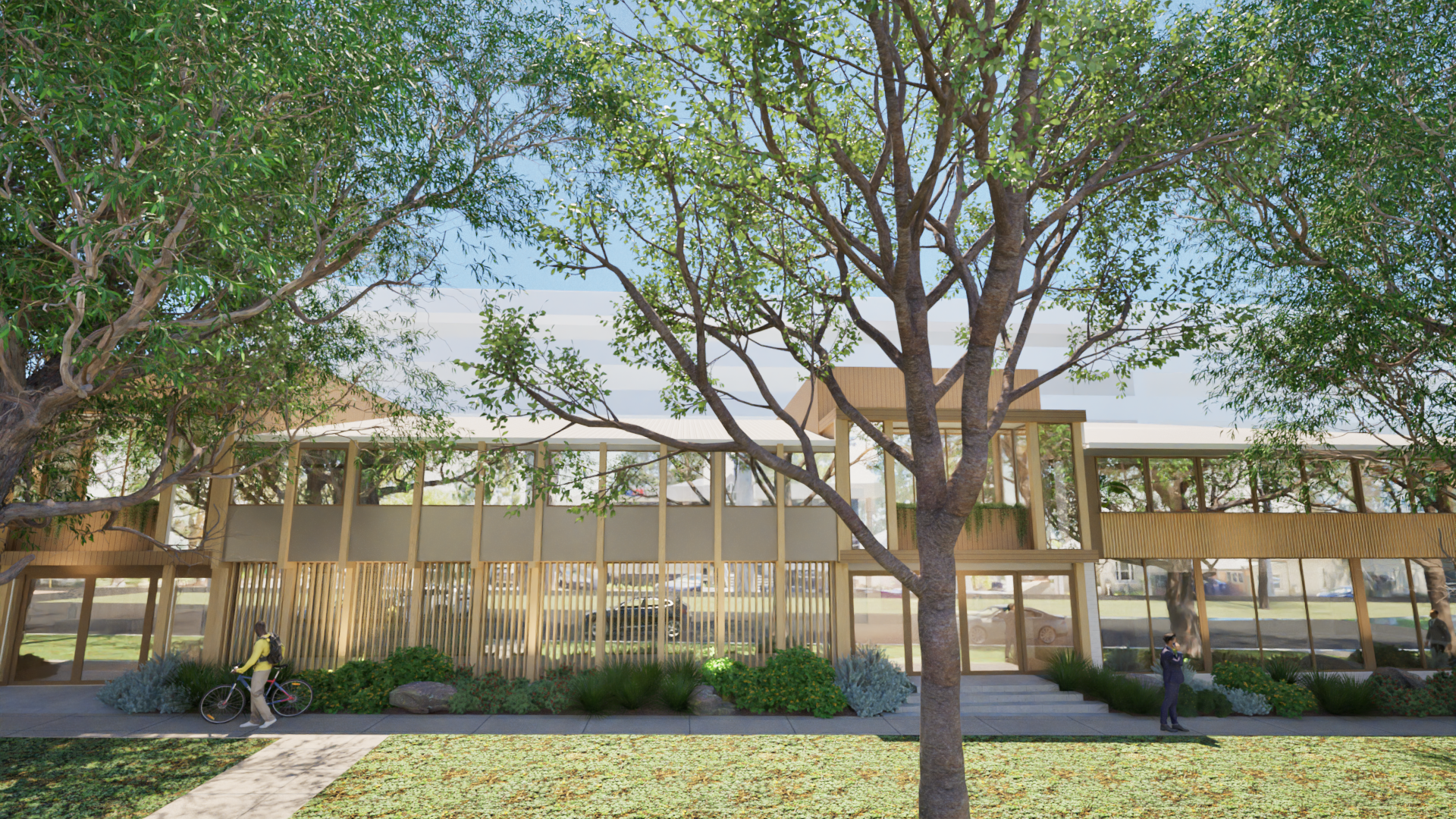 Modern building with large windows in a park-like setting, large trees, people walking and biking, greenery in the foreground.