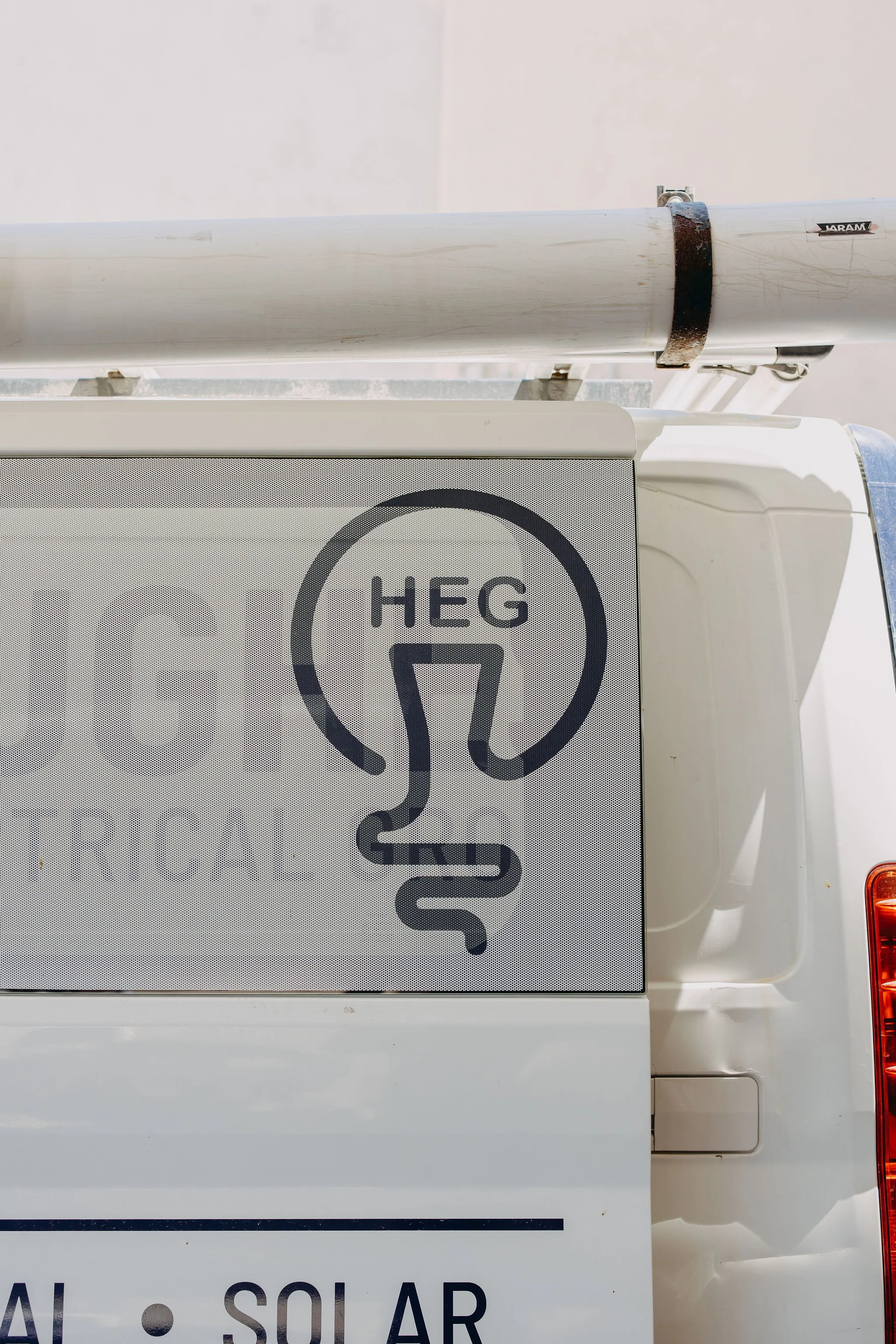 Close-up of a solar power unit with a sign showing a head wearing headphones, indicating a headphone warning.