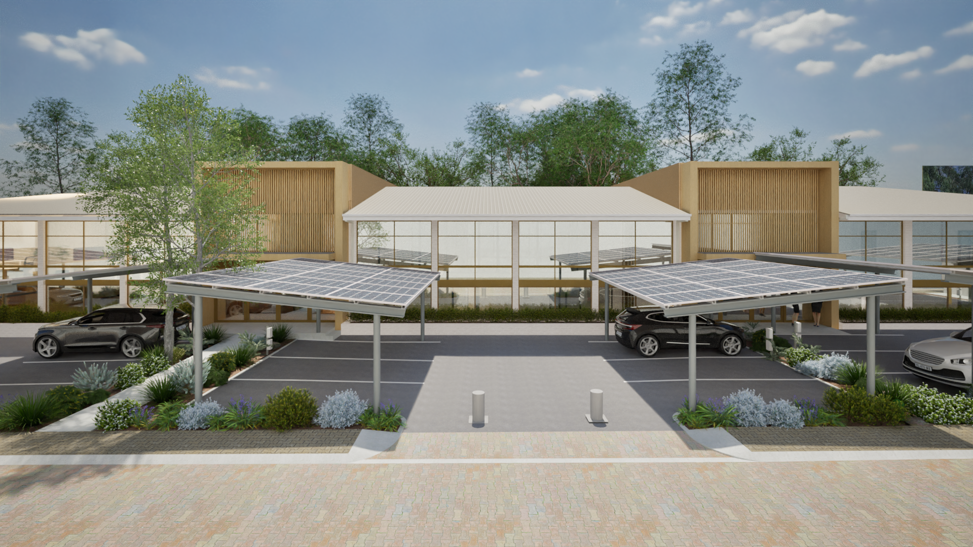 A modern building with solar panels on the roof and parking spaces in front. The building features wooden slat accents and large windows, surrounded by landscaped plants and trees.