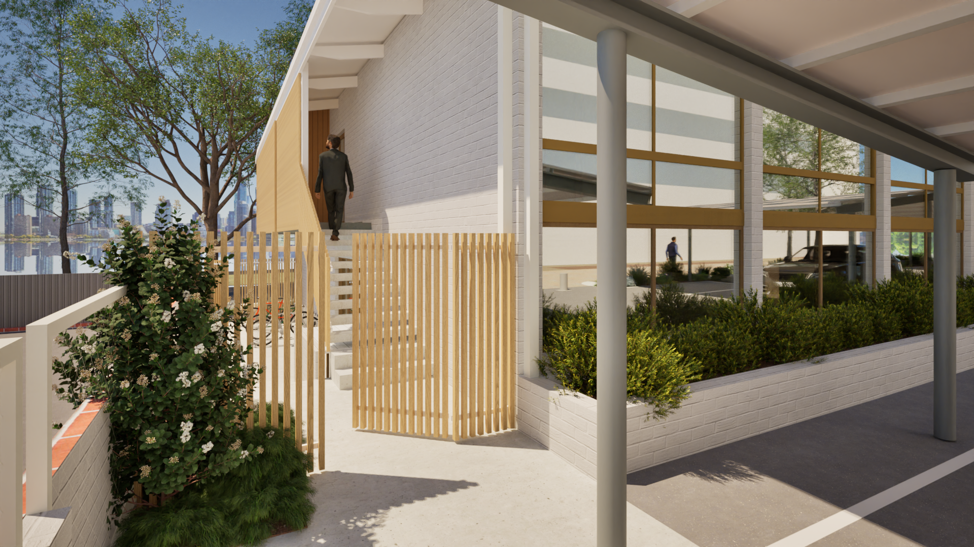 Modern building exterior with large windows, wooden accents, green landscaping, and a person walking up stairs toward the entrance.