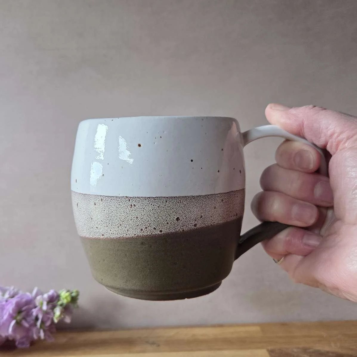 brown and white mug in hand.jpg