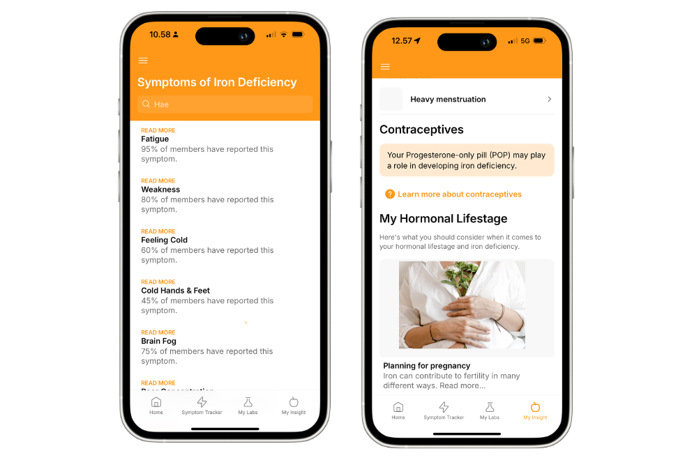 A person holding a smartphone with a health app open, showing recent test results, with beige vases and a white fabric backdrop on a marble surface.