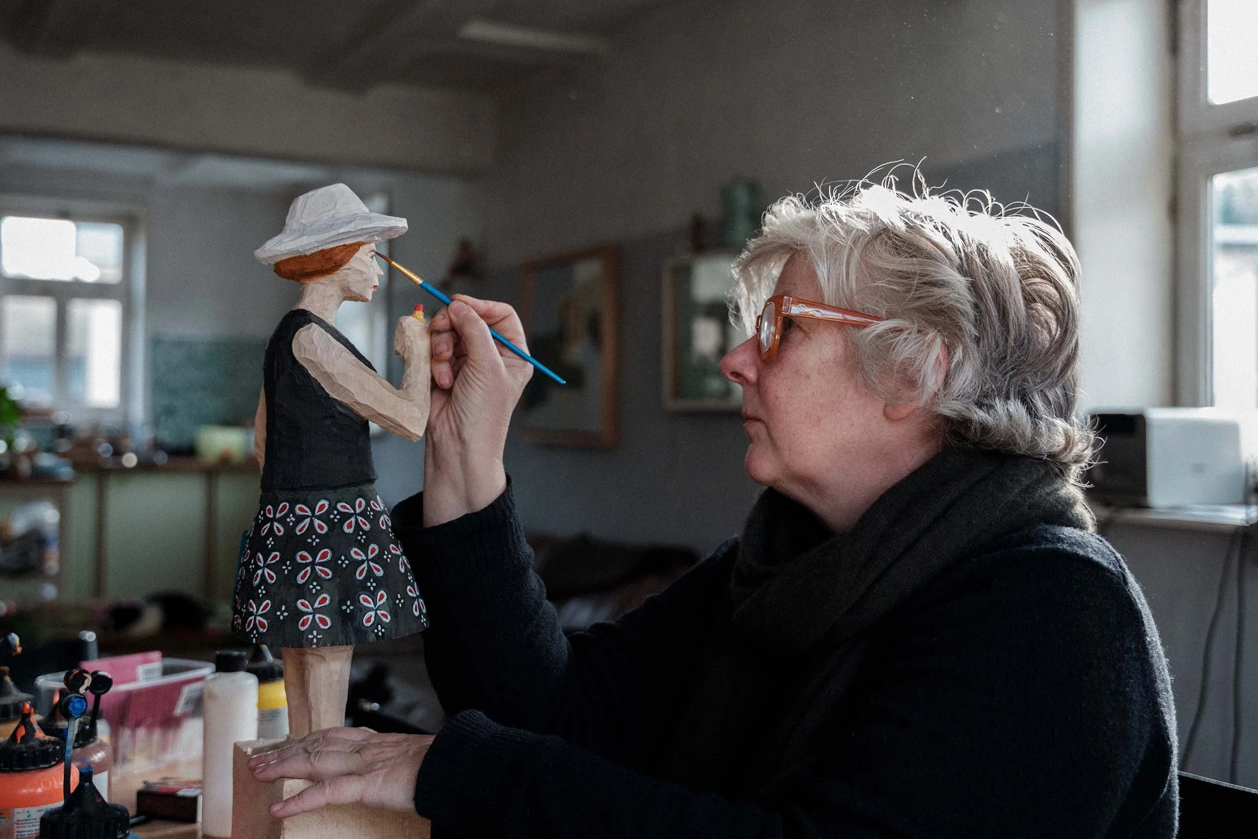 Kristina Fiand bemalt Figur in Atelier