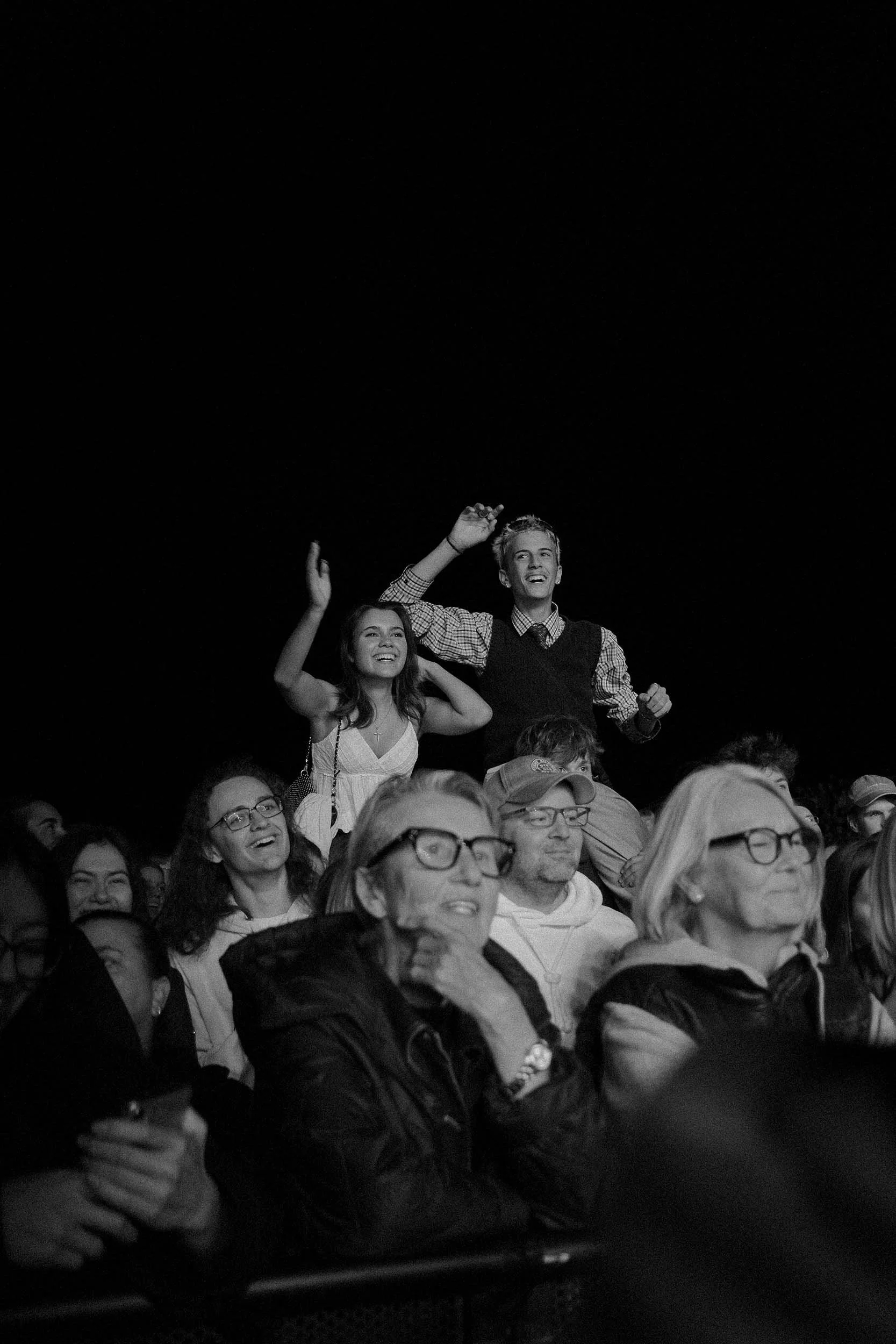 Publikum bei Konzert in Kassel mit erhobenen Händen in Schwarz-weiß
