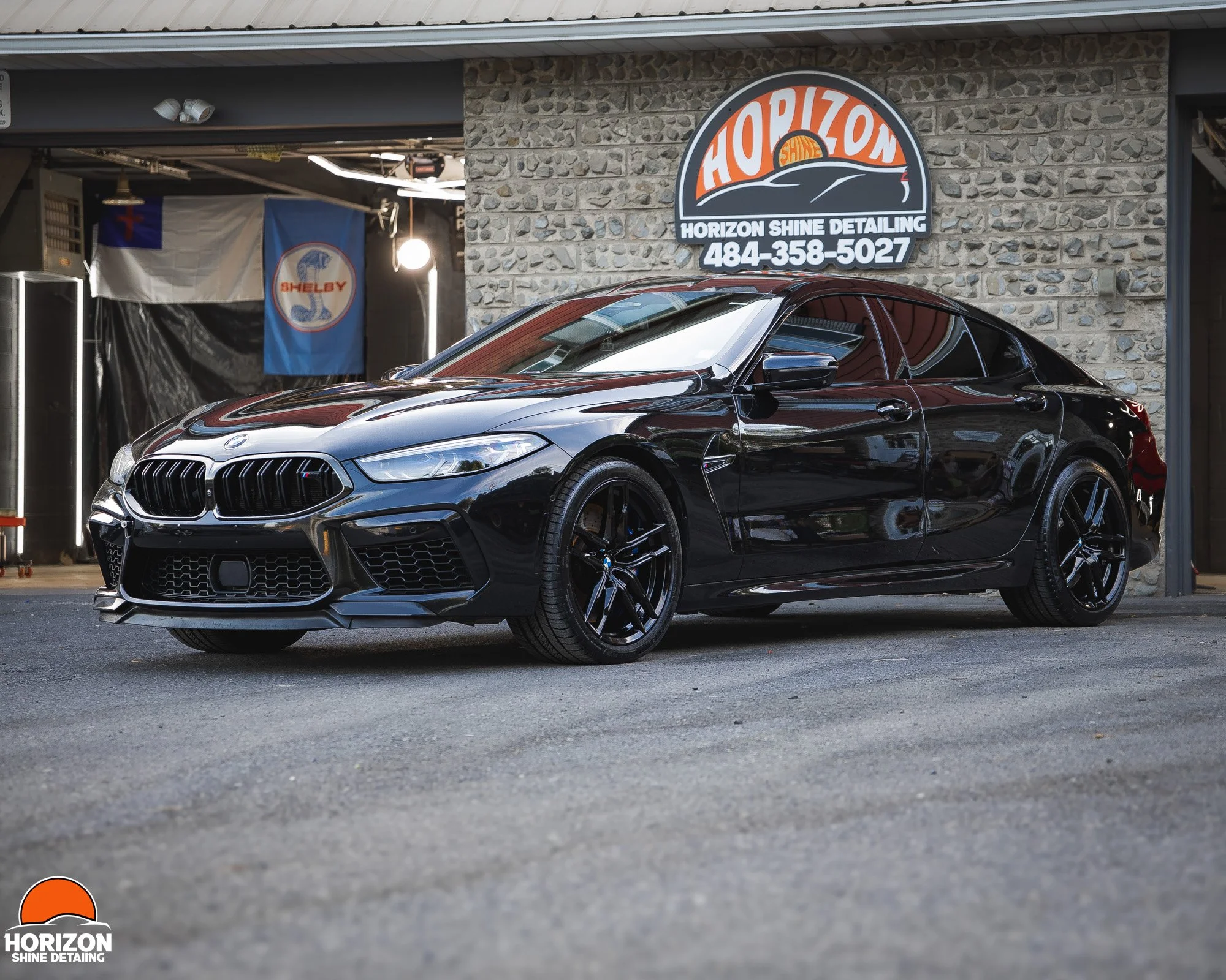 black bow M8 sedan parked in front of horizon shine detailing
