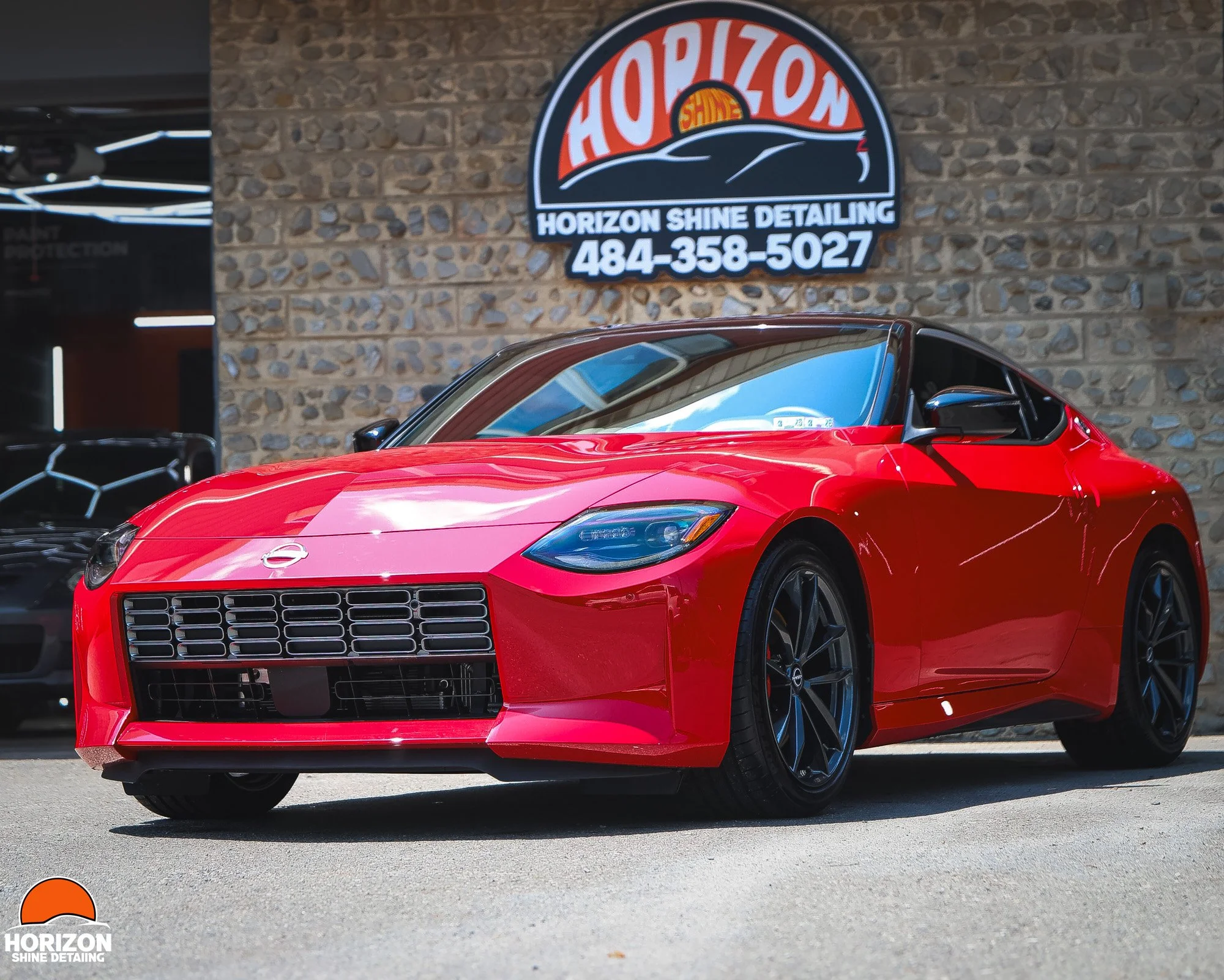 Red Nissan Z Displayed in front of horizon shine detailing