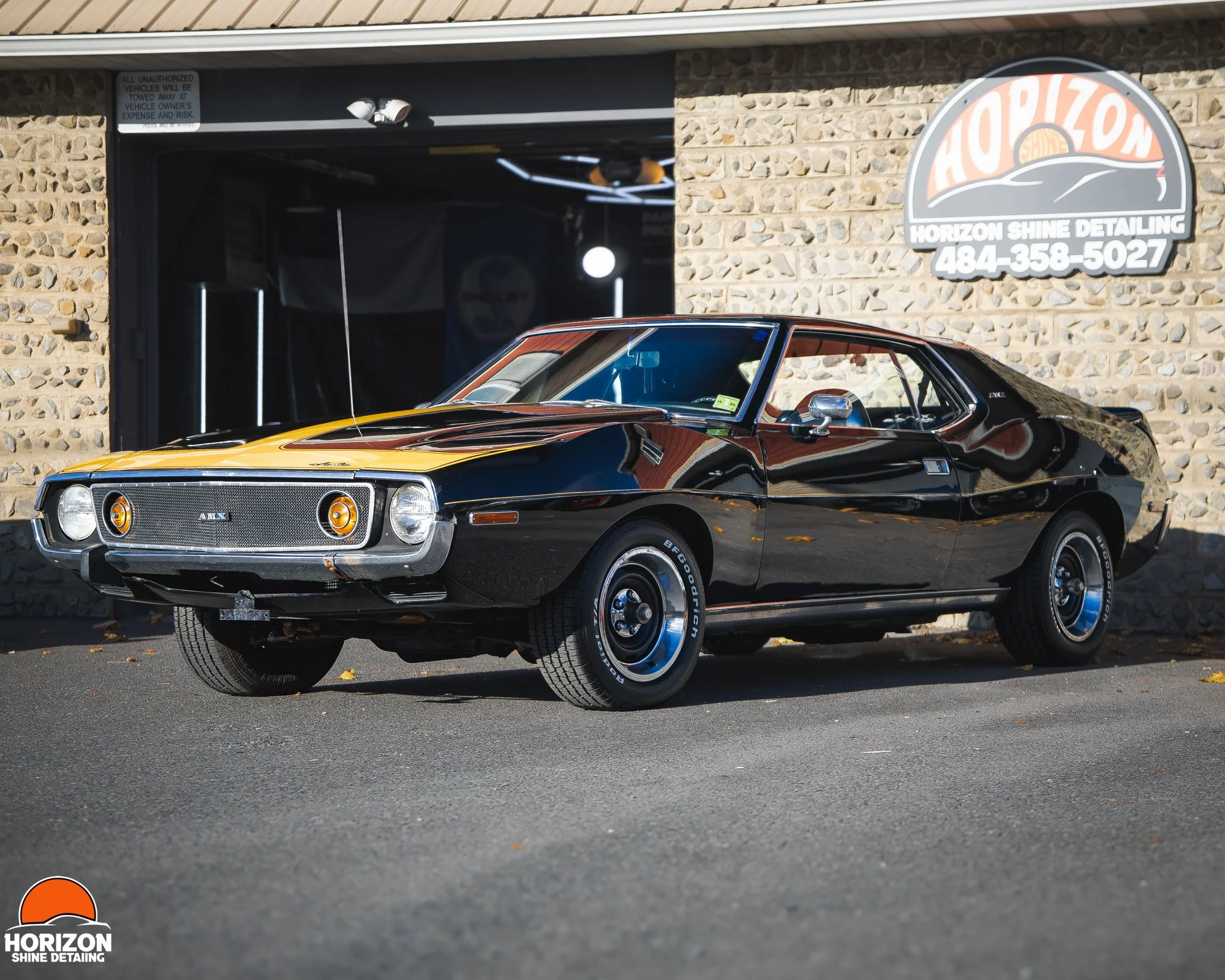 classic black and yellow AMC Javelin Parked in front of horizon shine detailing shop