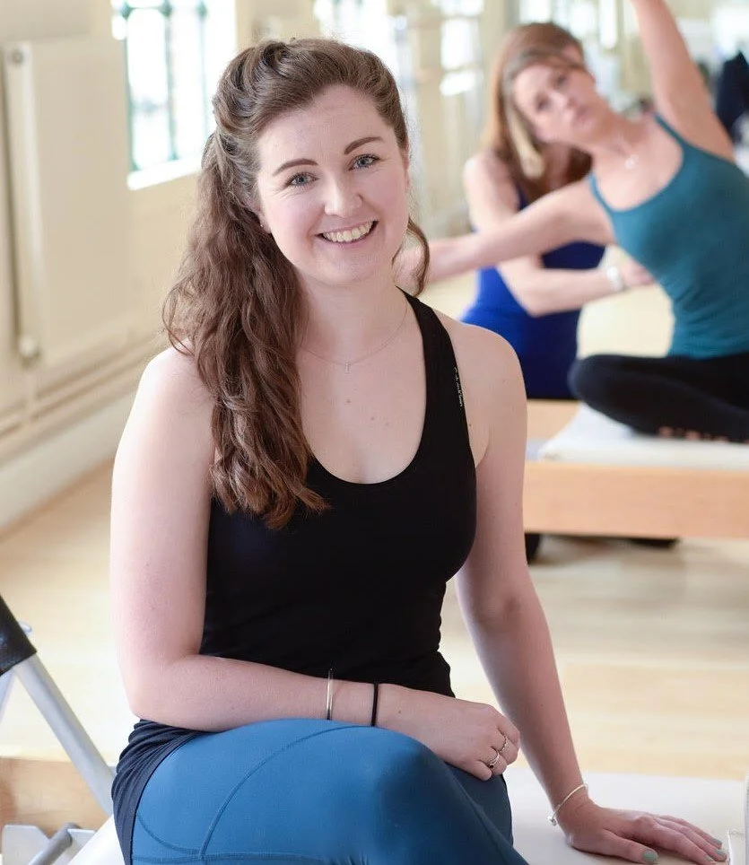 Logo for Pilates East with the word 'Pilates' in large letters and 'east' in smaller, curved letters underneath.