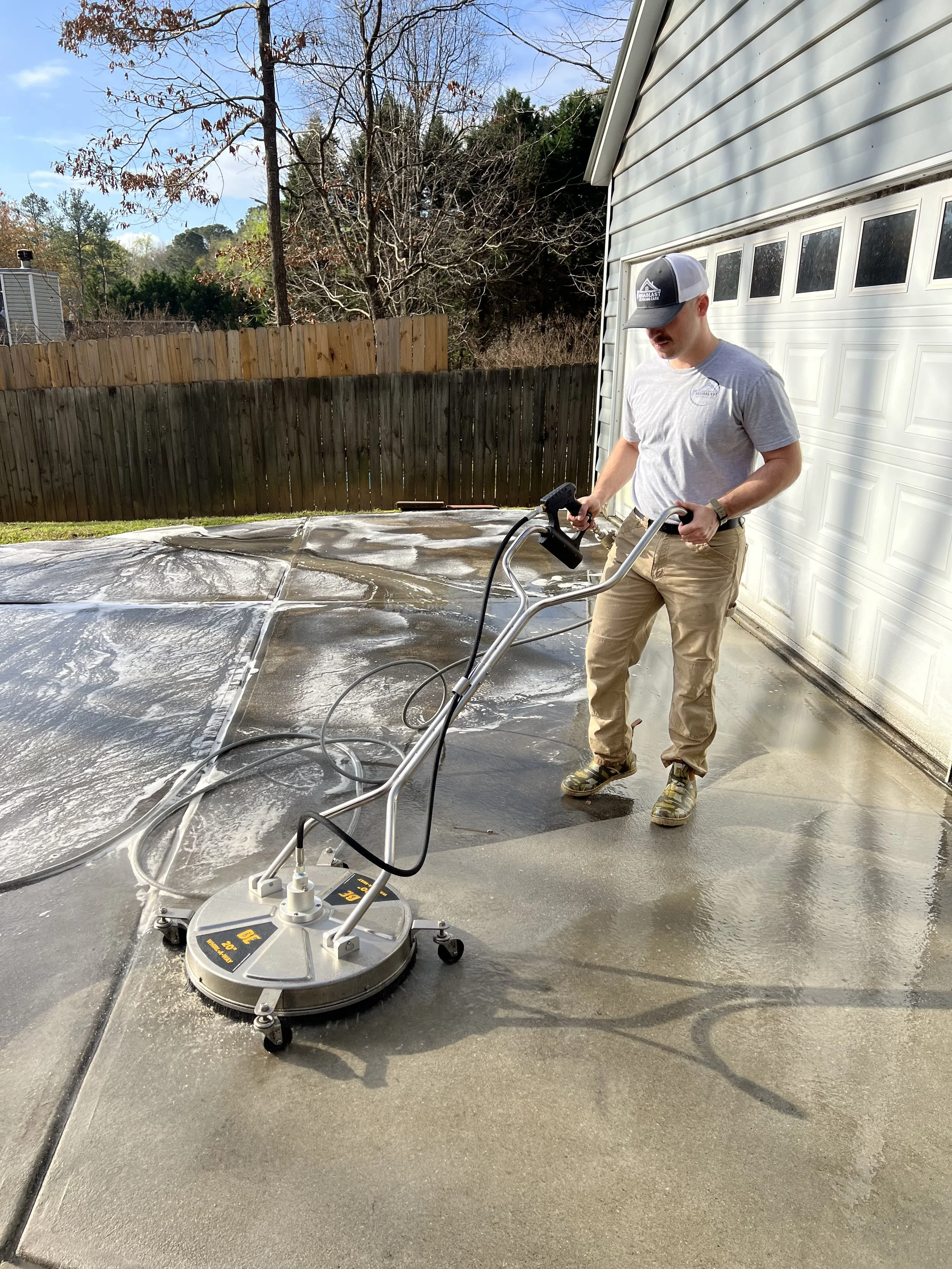 pressure washing a concrete driveway with a surface cleaner