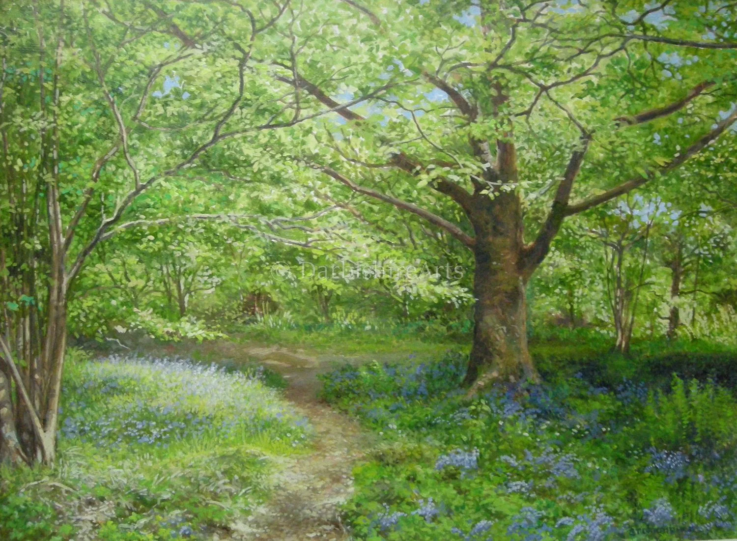 A lush, green forest scene with a large tree featuring a thick trunk and sprawling branches, a dirt path winding through the forest, and various smaller trees and plants, including purple and white flowers along the ground, under a canopy of bright green leaves.