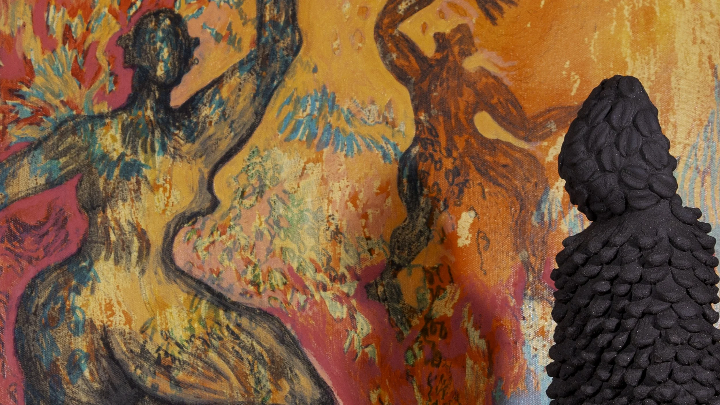 a sculpture of an abstract figure made from dark clay sits in teh foreground insfront of a colourful painting of figurative bodies of colour dancing
