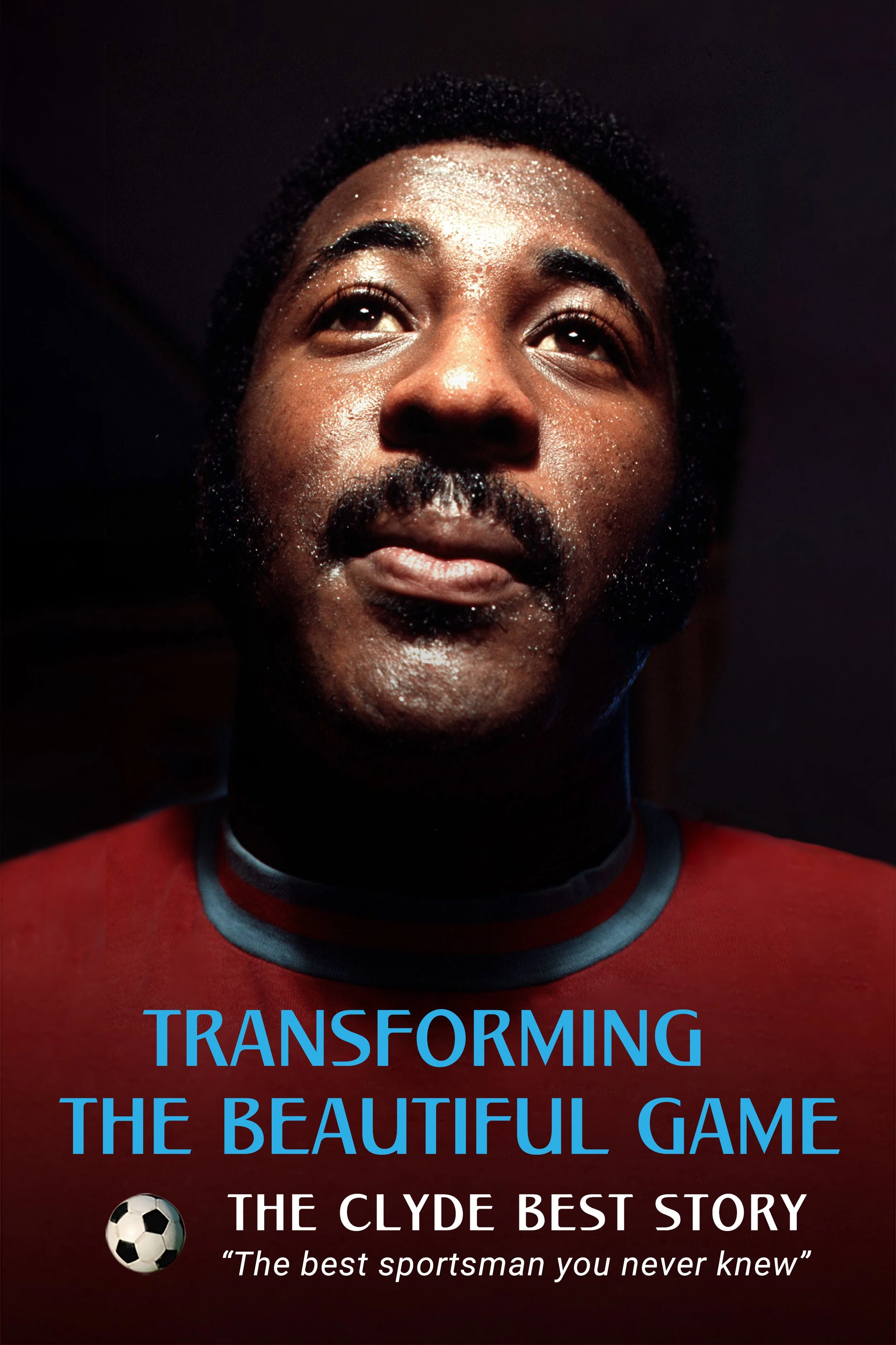 a picture of Clyde Best, a black footballer,, he is wearing a football shirt, he looks up to the light, it is a portrait.