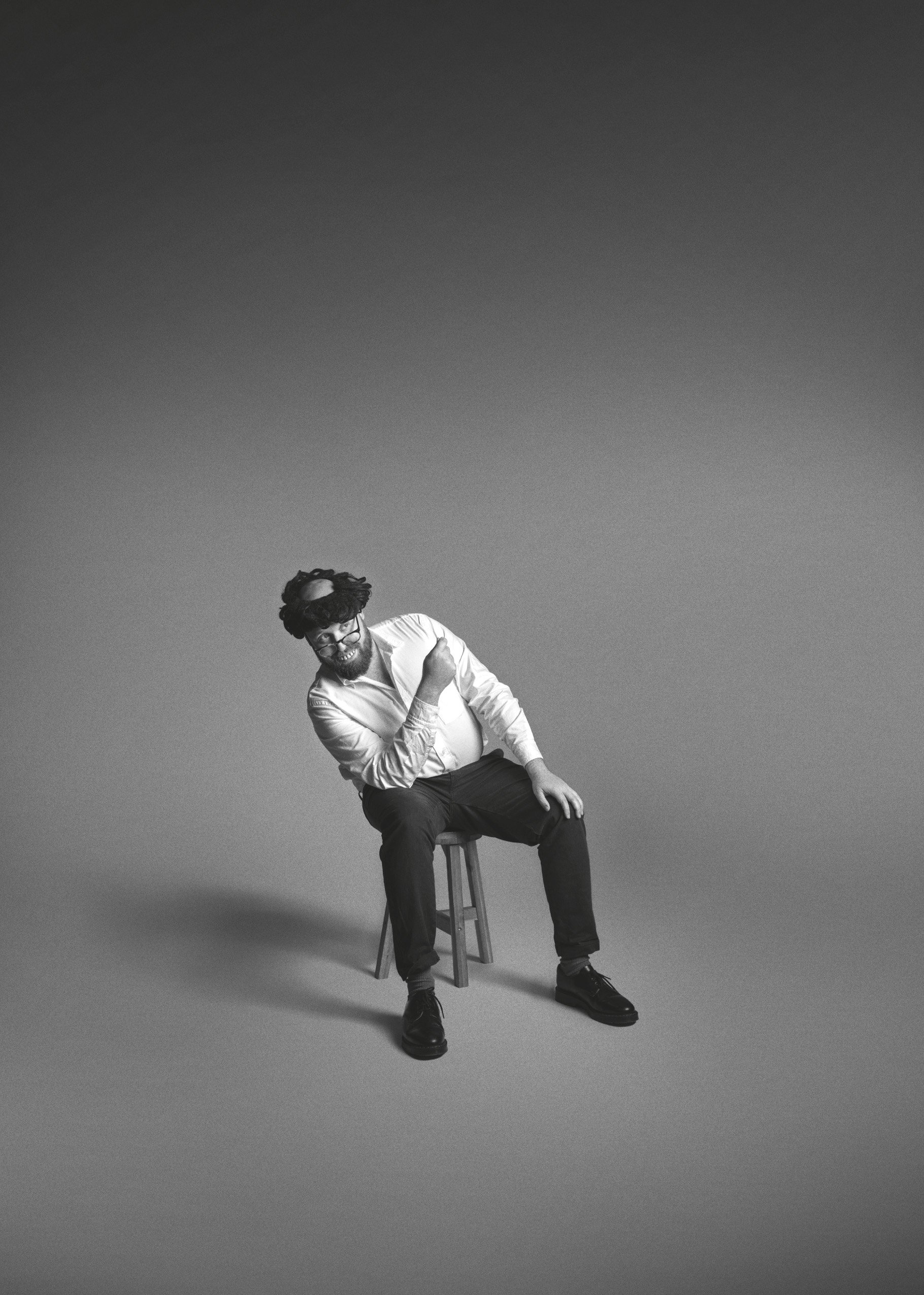 A black and white photo of John Kearns, sitting with a bandana around his head.