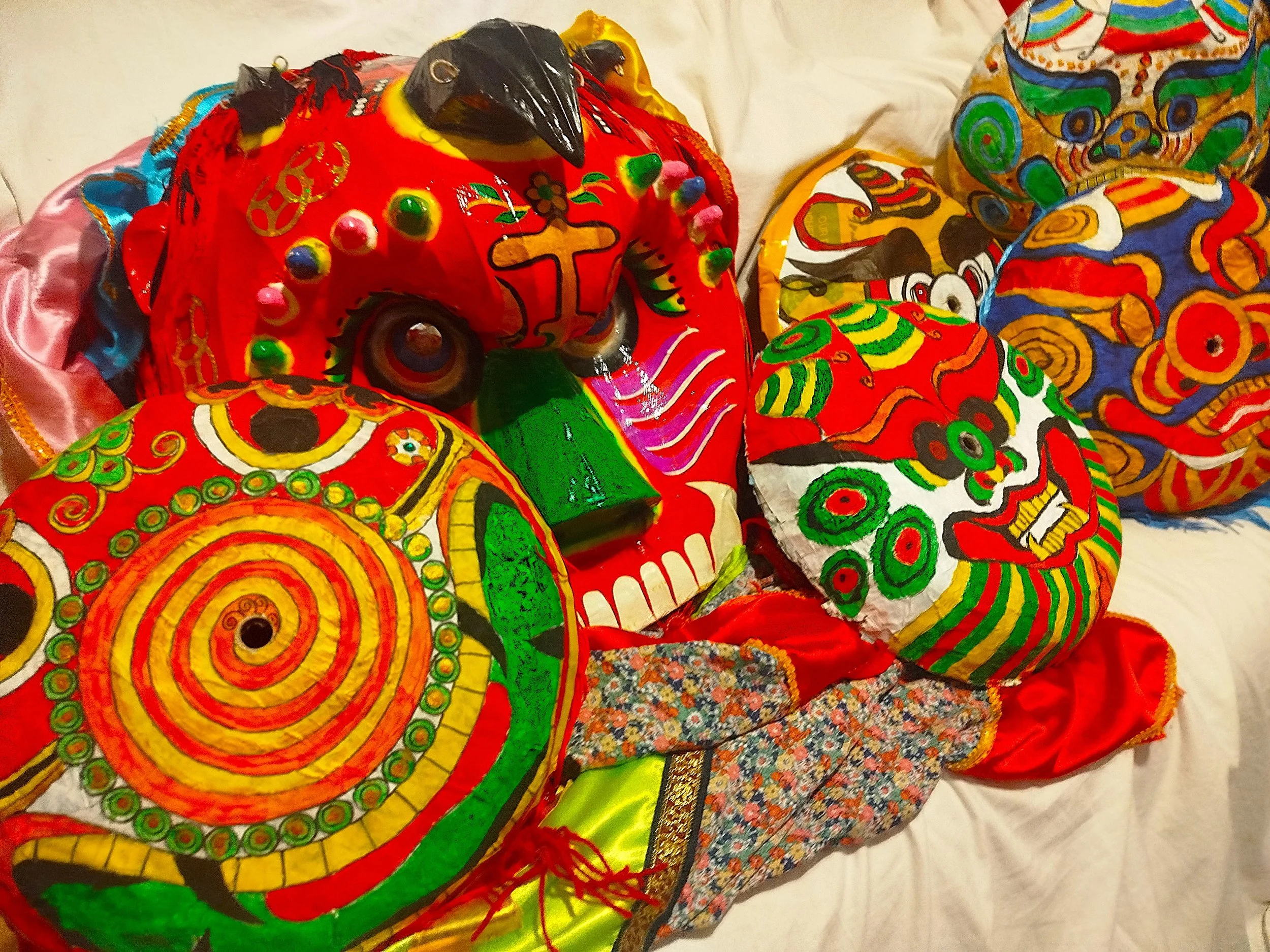 Some brightly coloured traditional masks for Chinese New Year are displayed in this photo.