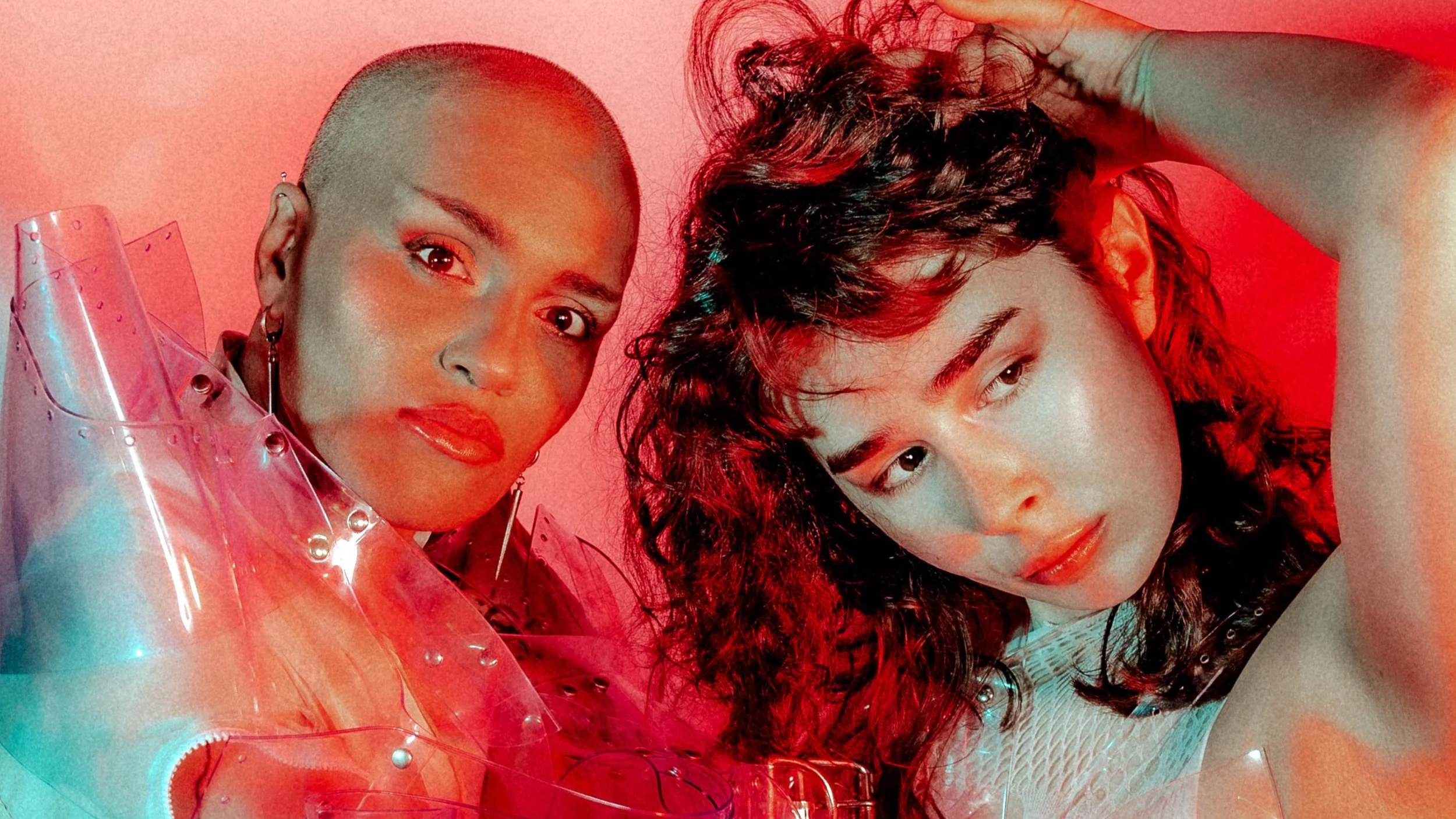 Two people in eccentric Carnival costumes pretend to kiss