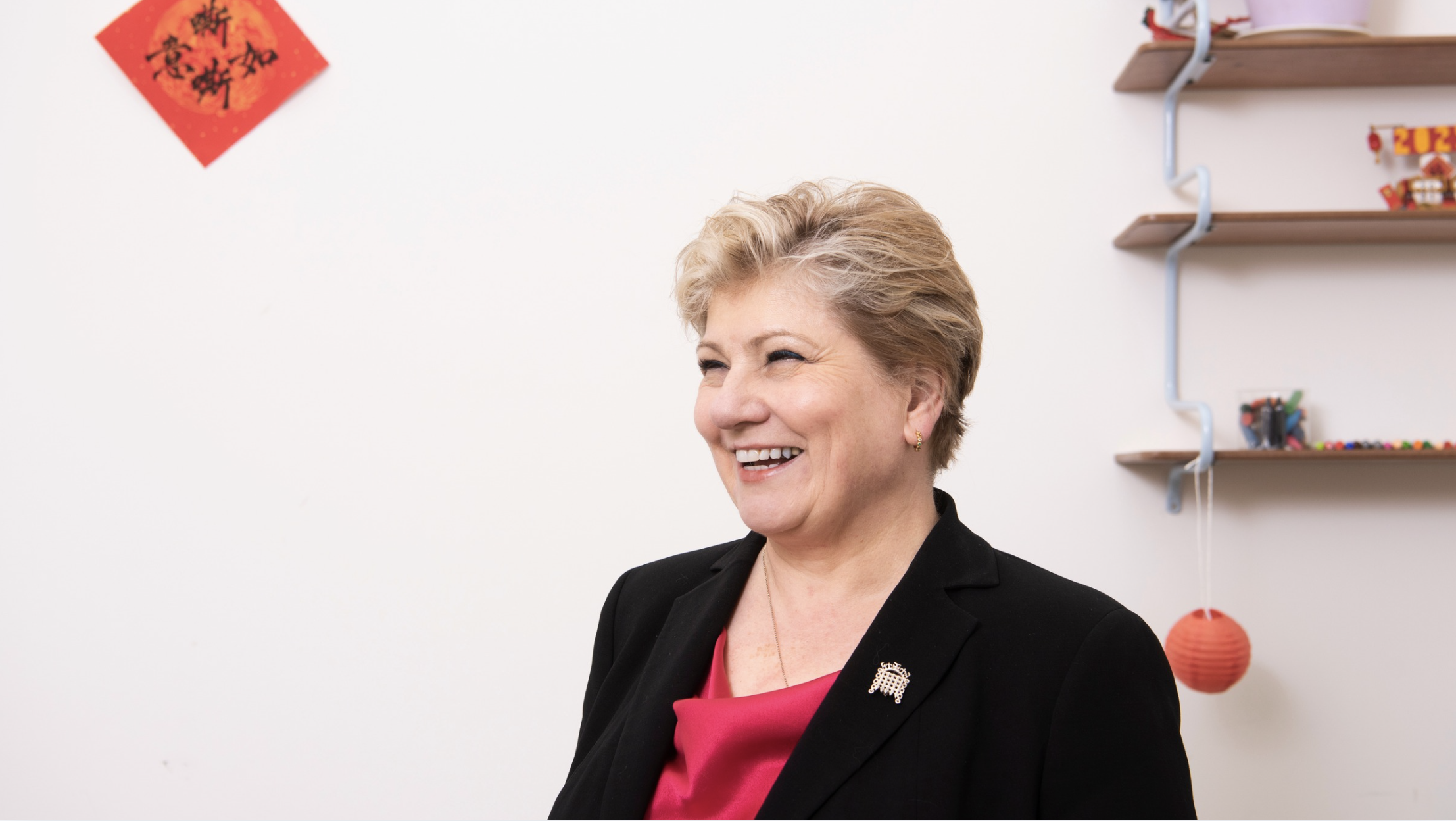 A woman looks to her side smiling