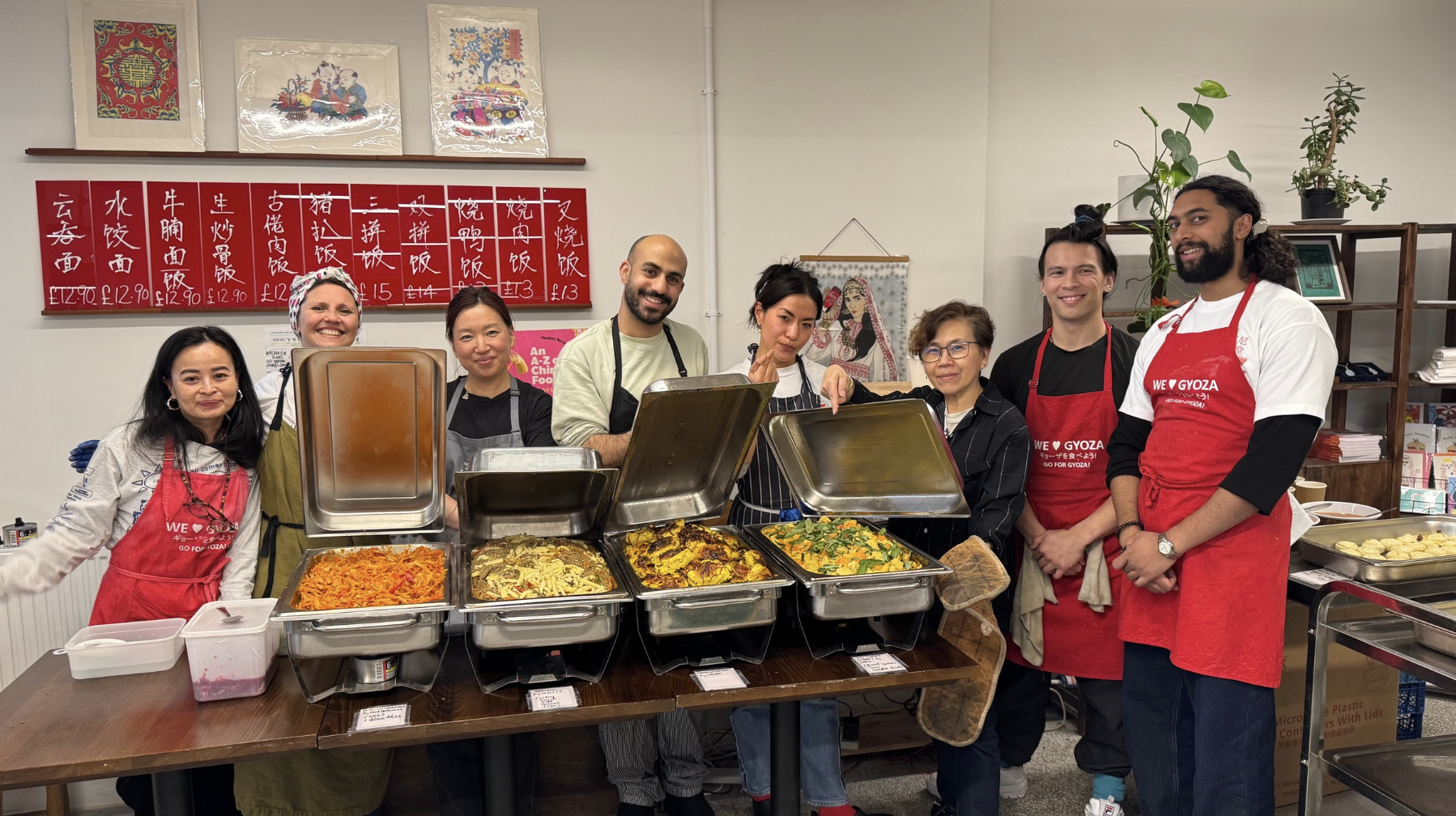 A group of people in aprons in front of a buffet