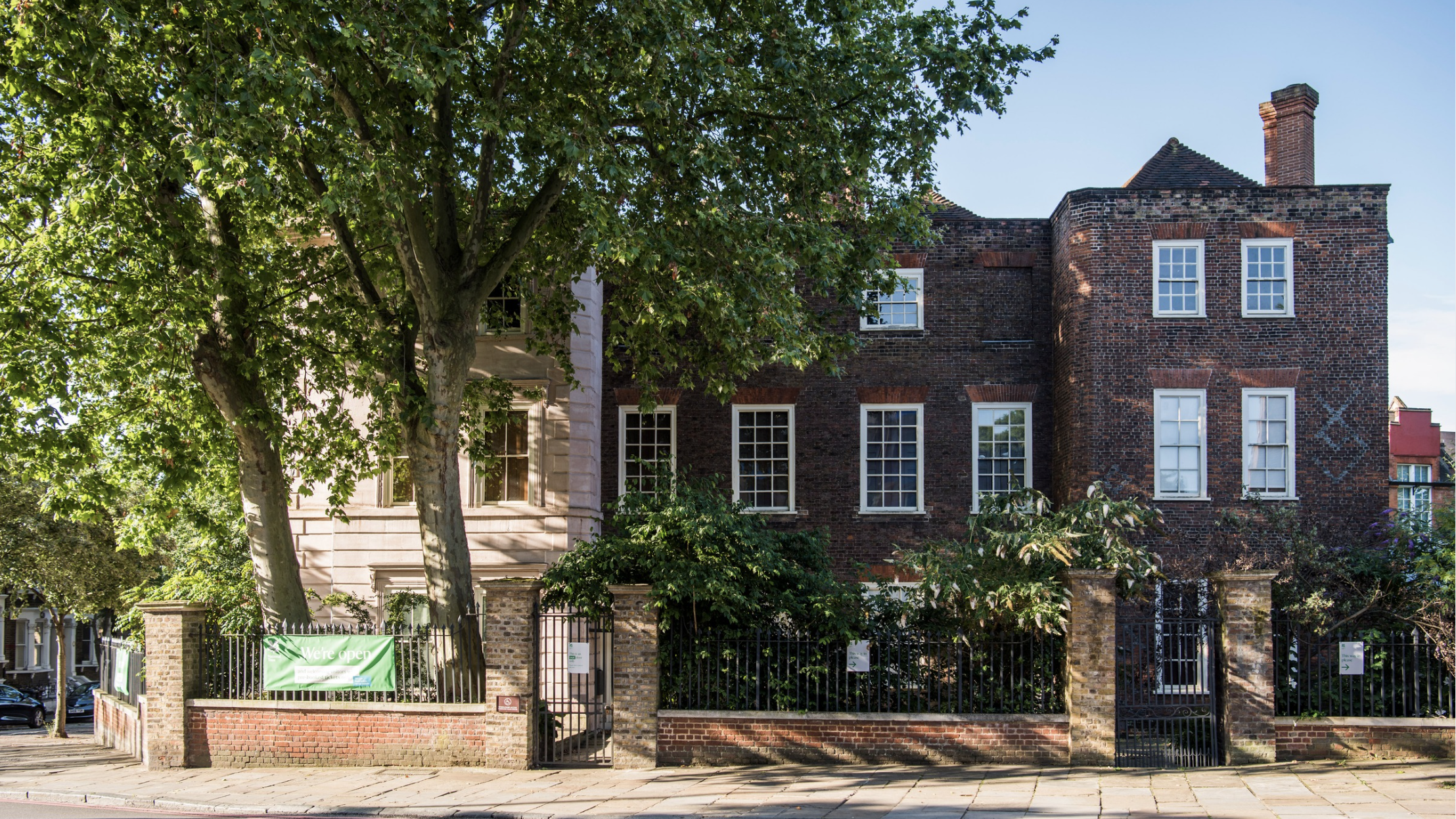 An old Tudor House next to a tree