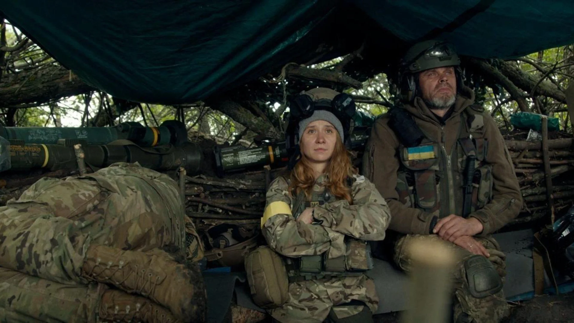 Two soldiers sitting in a barrack.