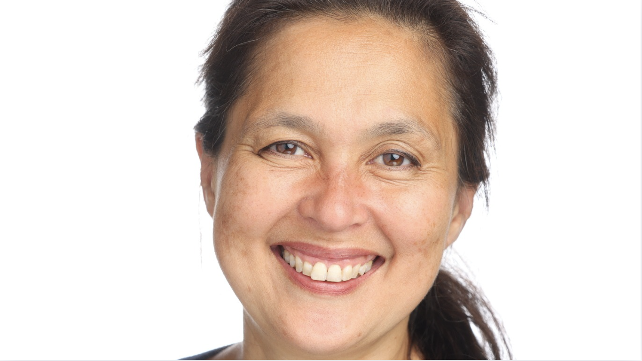 A woman with brown hair smiles