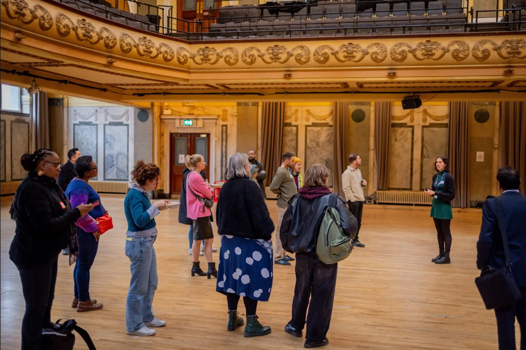 A group of people standing in Shoreditch Town Hall.