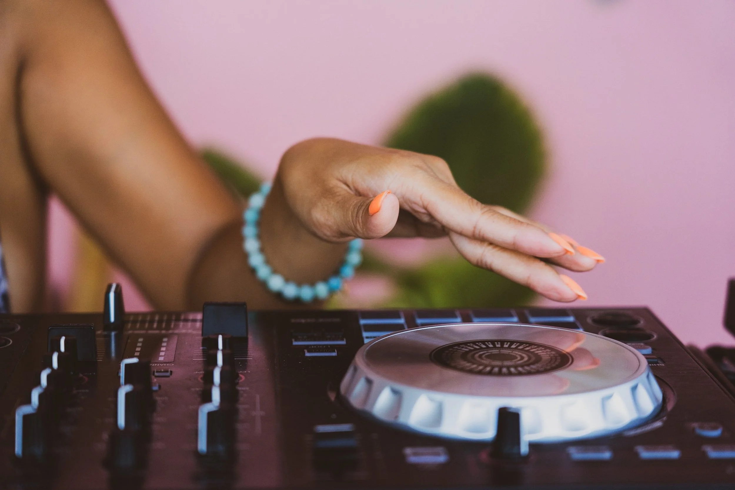 A woman's hand over a DJ deck