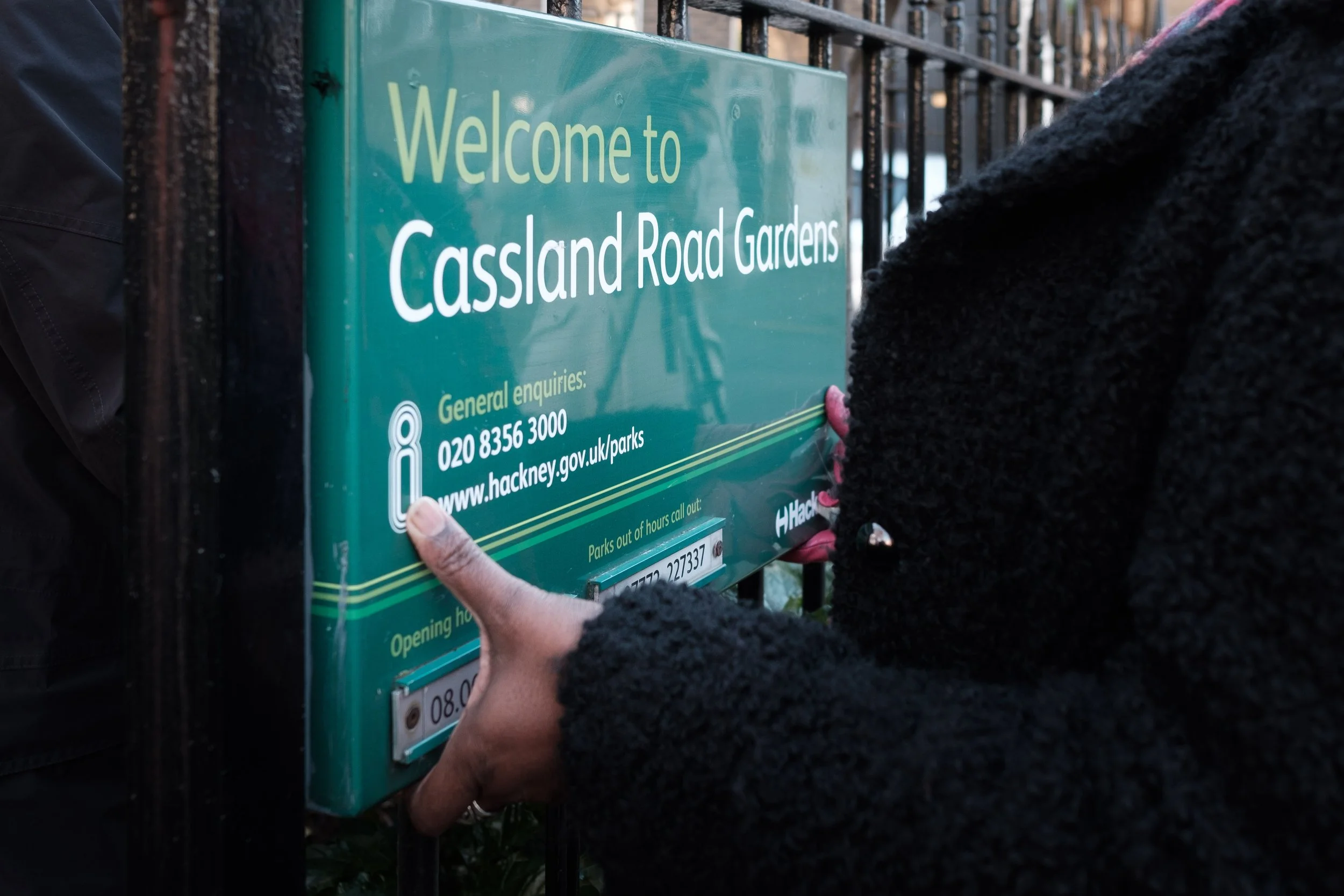 Person with brown skin removing the park sign in year2020