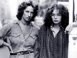 A black and white photo of two women in the 70s