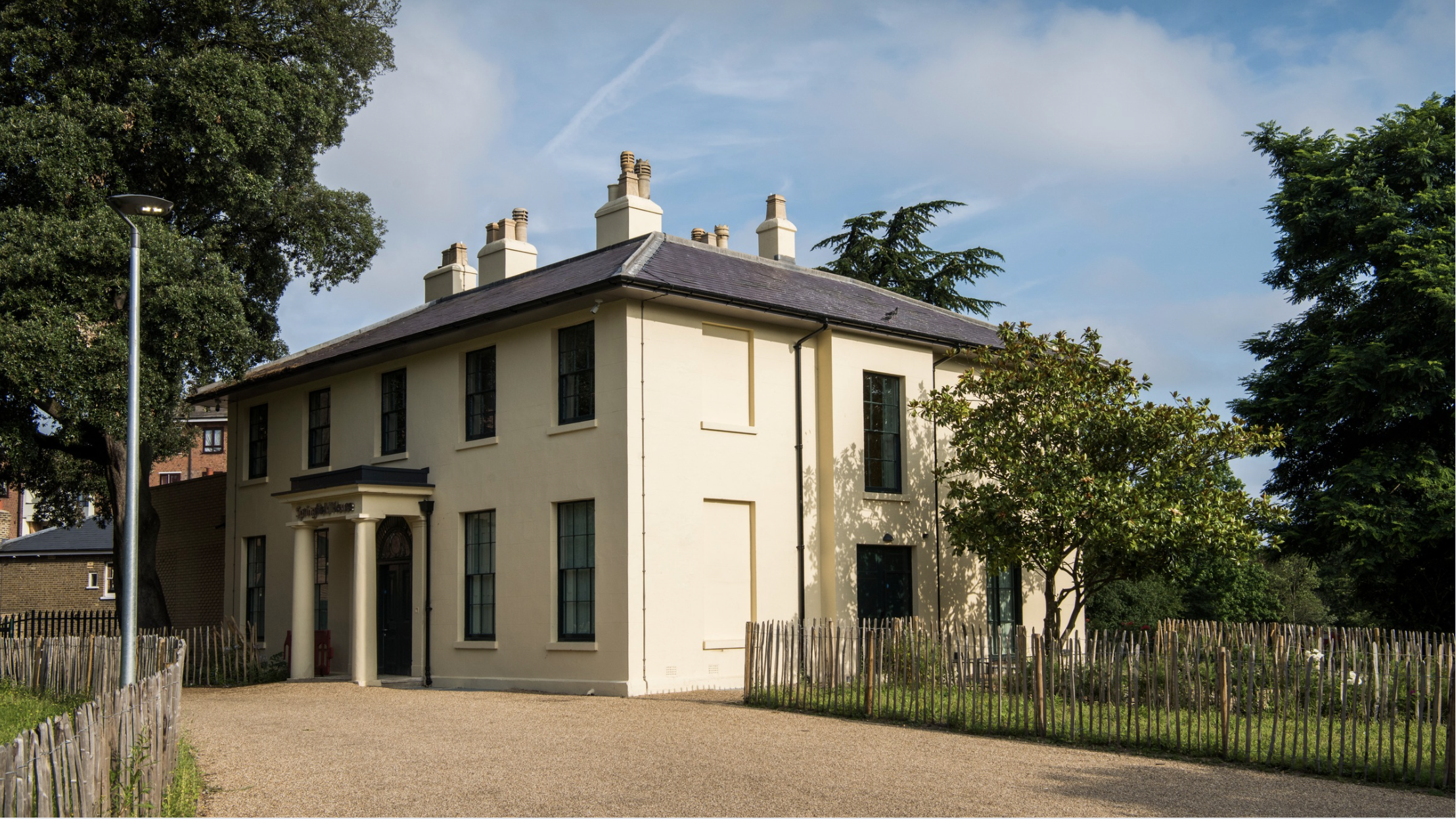 A grand white house against a blue sky