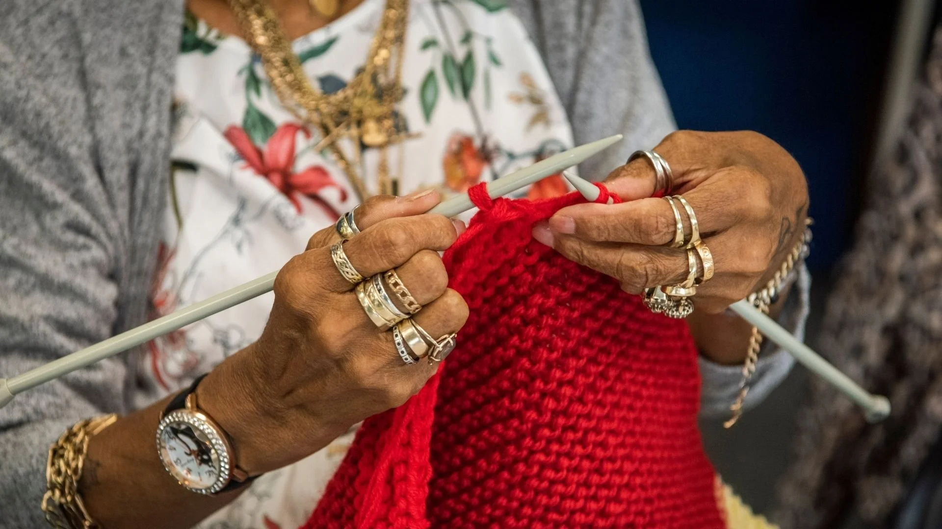 Hands knitting red fabric
