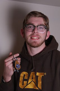 A headshot of a man with car keys
