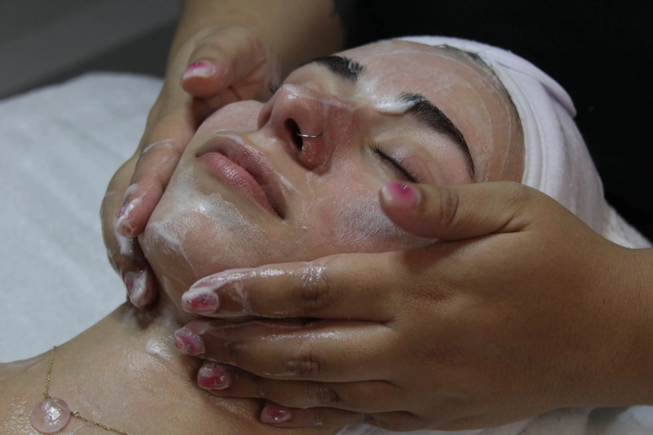 An action shot of a facial being done