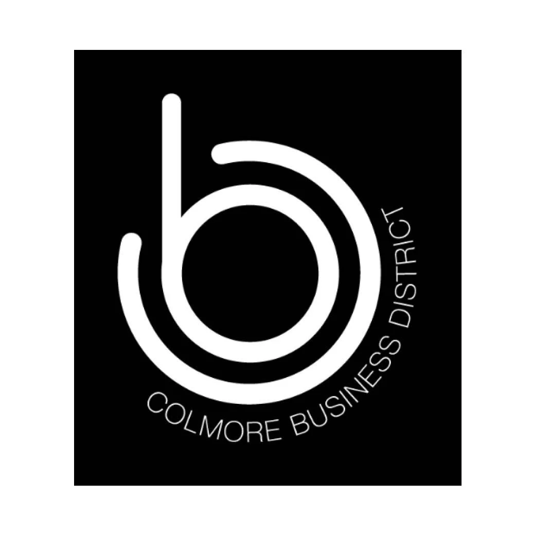 Logo for Colmore Business District, featuring a stylized white circular design on a black background with the text 'COLMORE BUSINESS DISTRICT' curved along the circle.