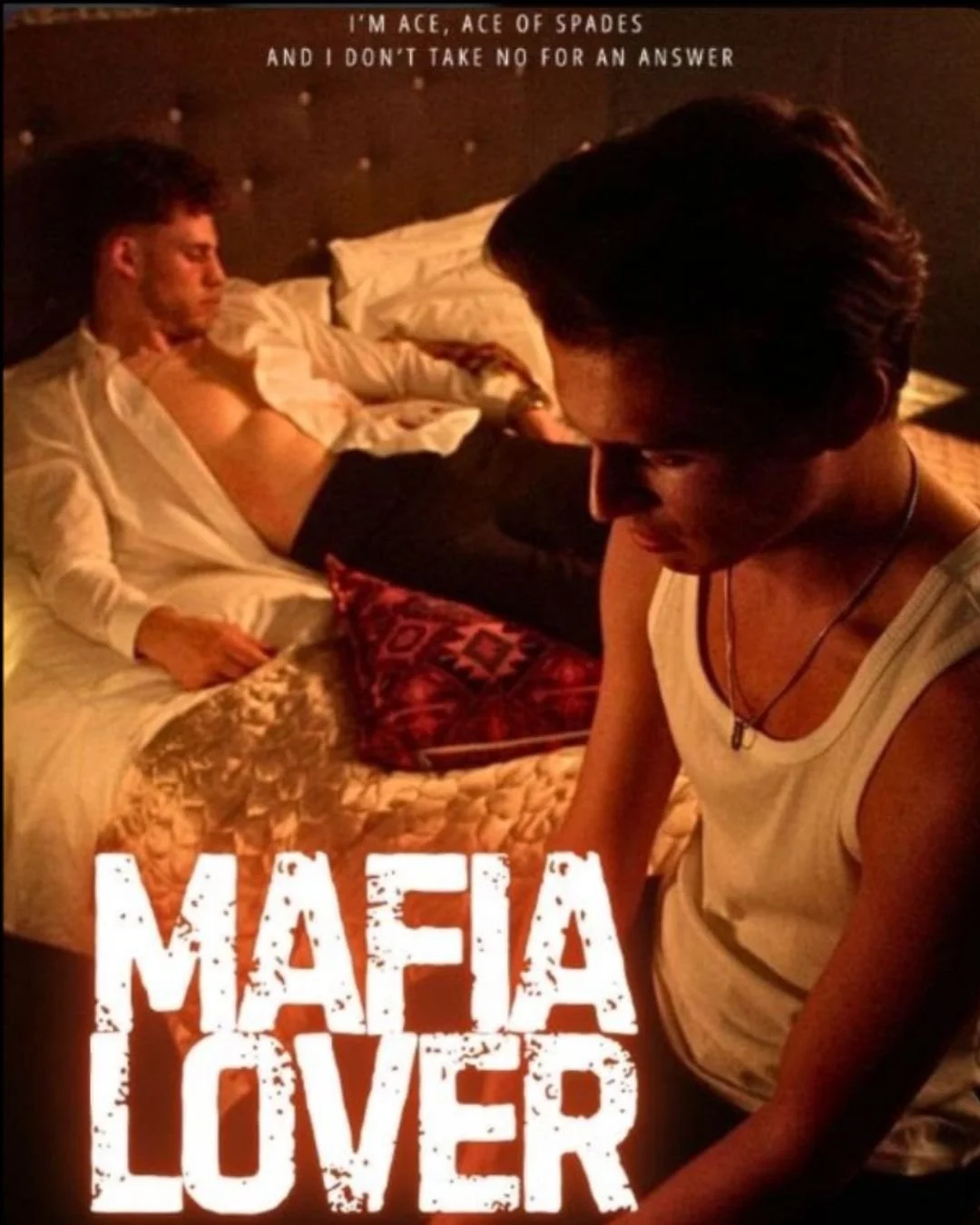A young man is sitting on the floor, looking down, in front of an unbuttoned shirt man reclining on a bed. The shirtless man appears relaxed with eyes closed, and there is a patterned pillow on the bed. The text overlay says: "I'm Ace, Ace of Spades and I don't take no for an answer." The title at the bottom reads: "Mafia Lover."