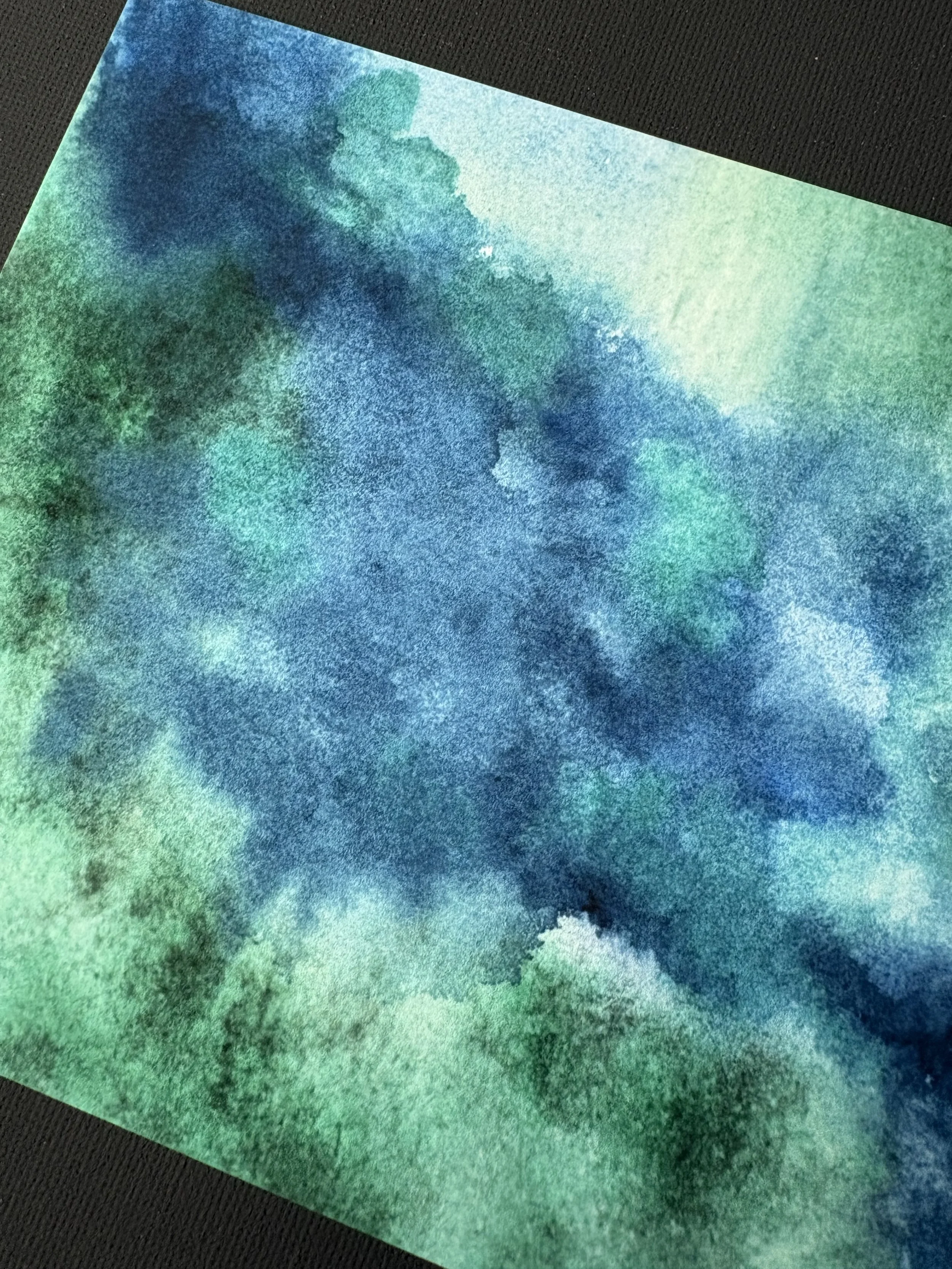 Abstract watercolor “Green Pastures, Still Waters” inspired by Psalm 23:2, with deep green and blue tones evoking peace, rest, and God’s presence.